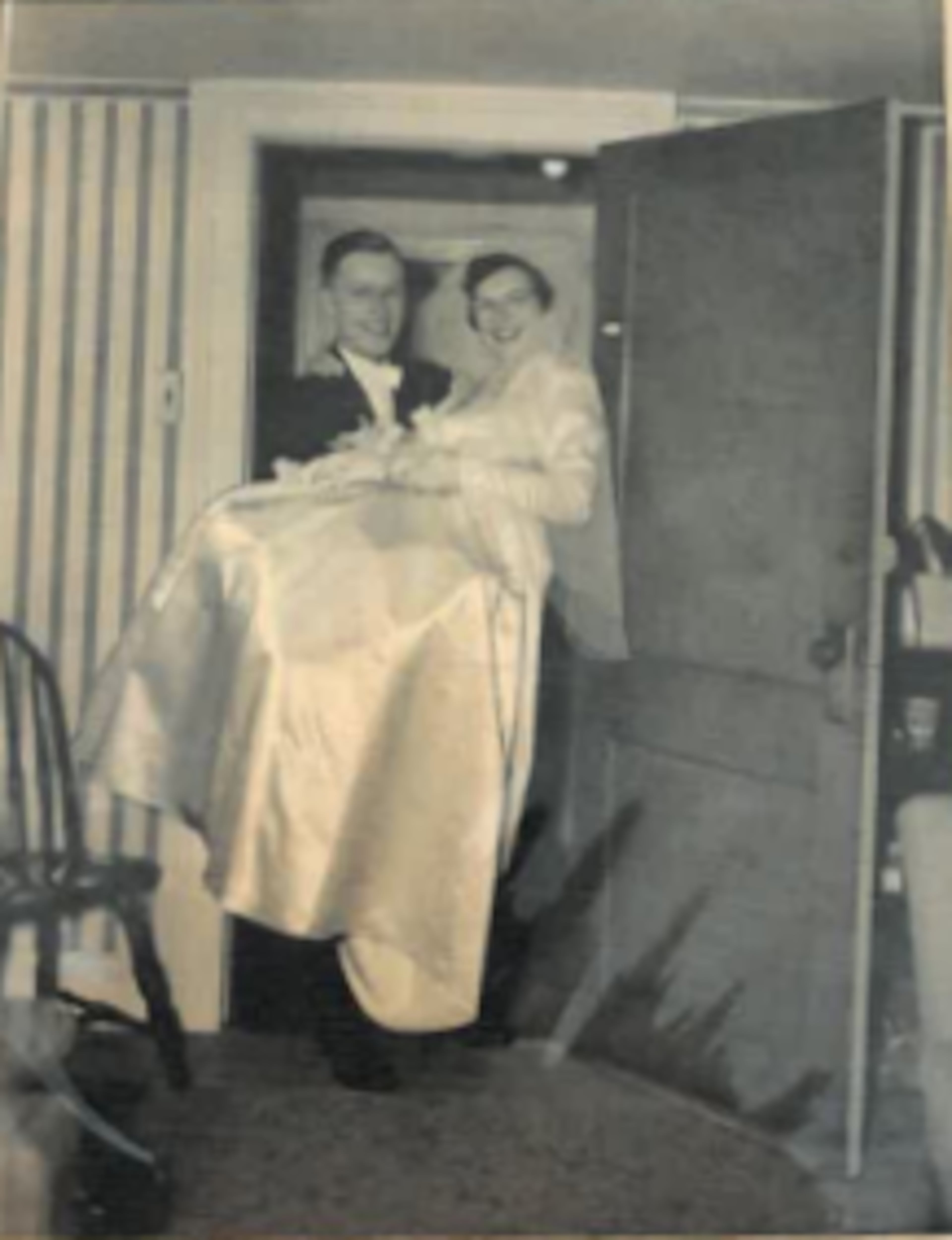 Ken Hetzel carries his bride, Ann Hetzel, through the threshold on November 22, 1950.