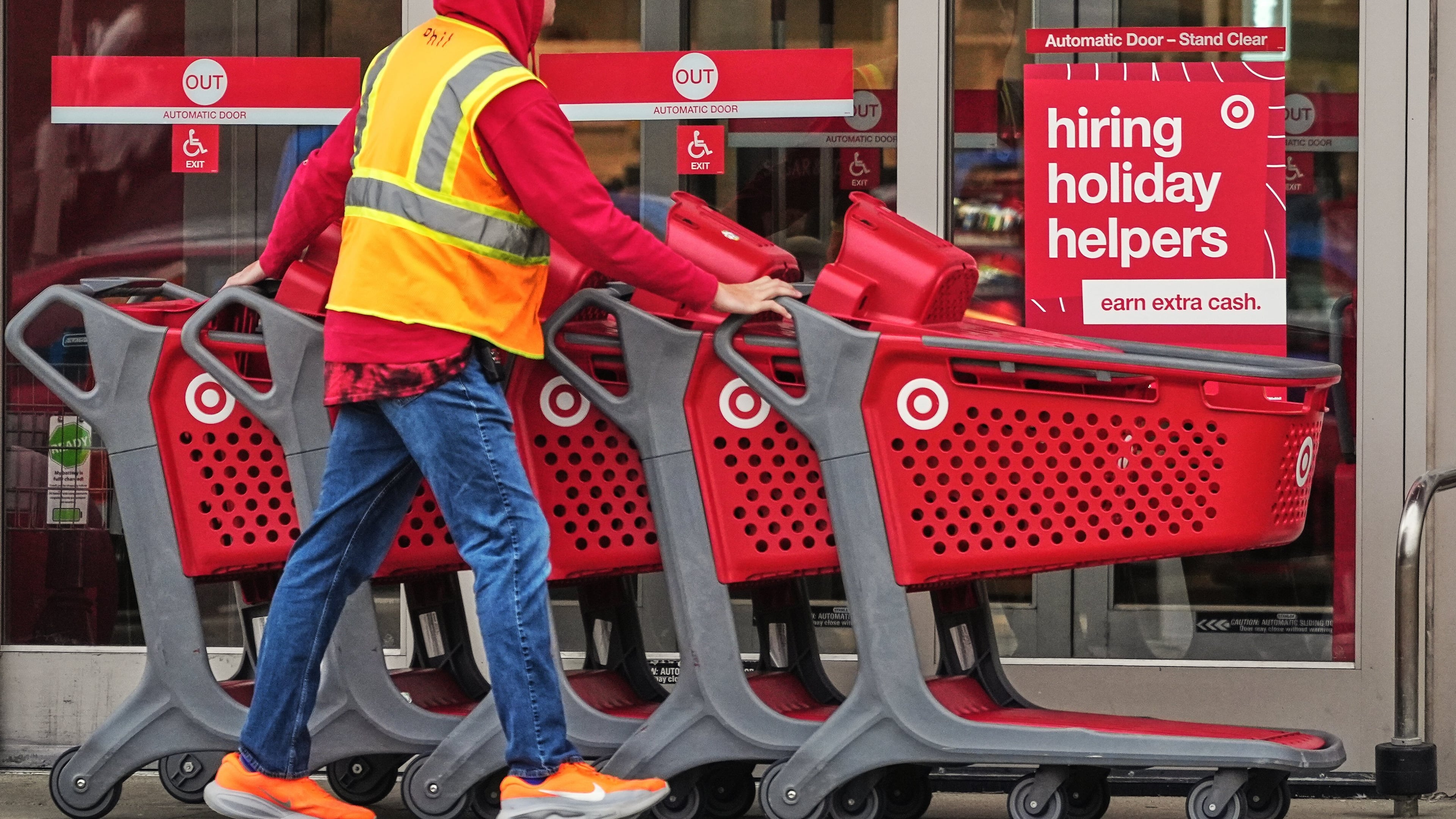 Signs for holiday hiring hang on the doors of a Target in Pittsburgh last year. Target plans to hire 2,300 seasonal employees for its metro Atlanta stores to meet demand this holiday shopping season, a company spokesperson says. (Gene J. Puskar/AP 2025)