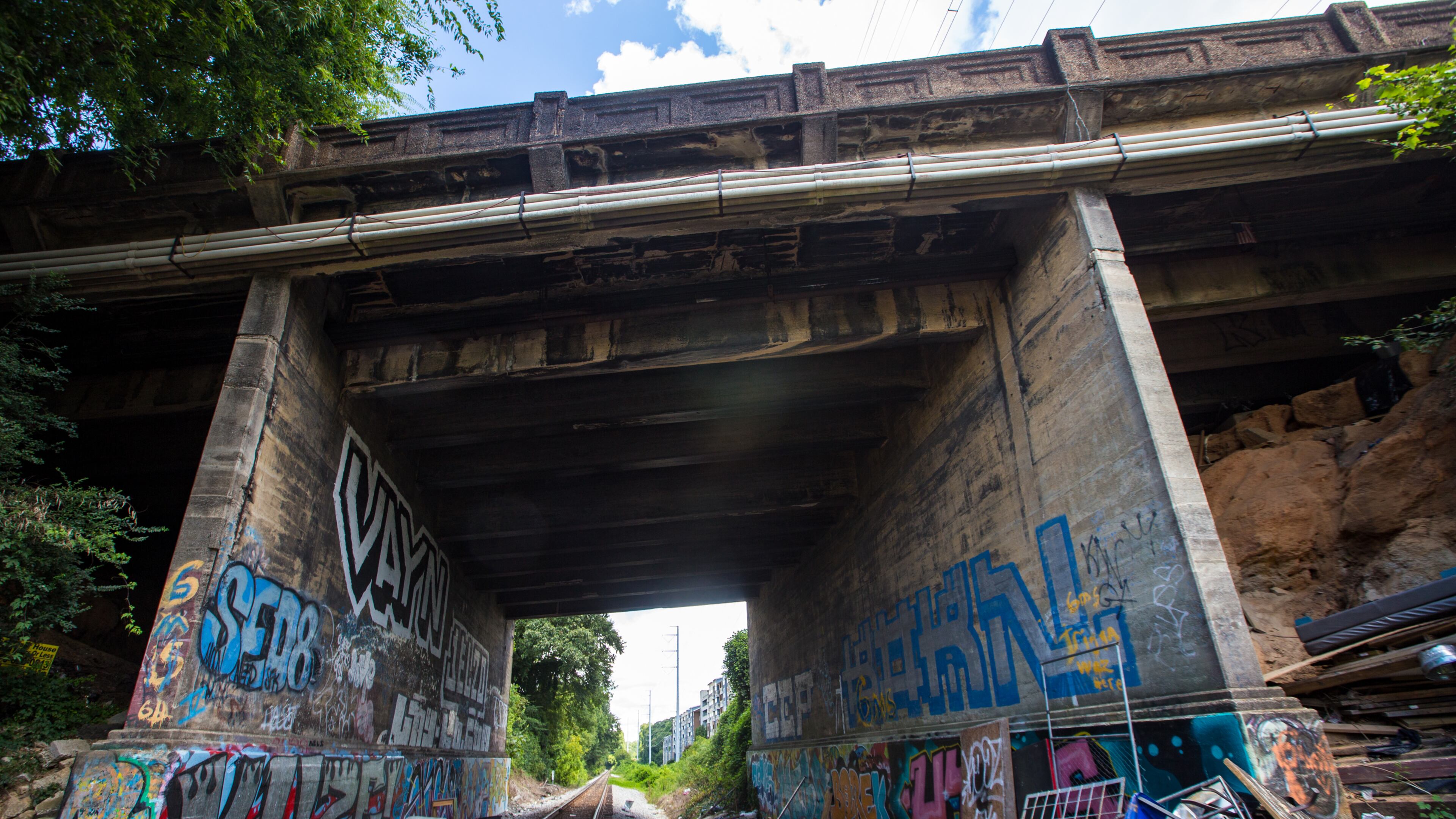 The northern portion of the Beltline will be the final section completed after designers work out how to deal with active rail lines. The Peachtree Road bridge here, photographed Sunday, Aug. 15, 2021, runs over the active rail line just south of Bennett Street and has a very narrow clearance. (Jenni Girtman for The Atlanta Journal-Constitution)