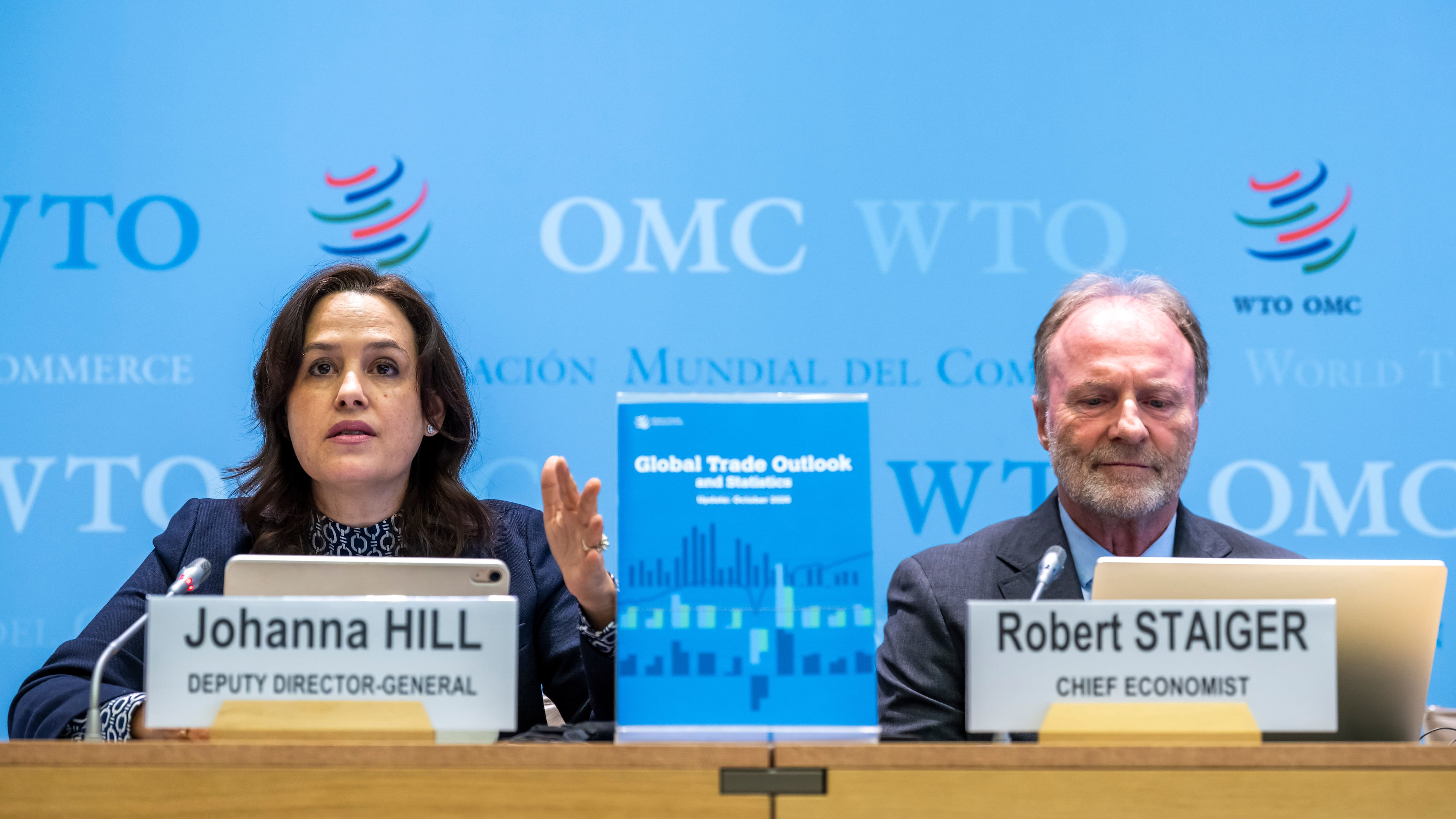 WTO Deputy Director-General Johanna Hill, left, and Robert Staiger, right, Chief Economist of WHO, talk to media about this WTO's "Global Trade Outlook and Statistics" during a press conference at the headquarters of the World Trade Organization (WTO) in Geneva, Switzerland, Thursday, Oct. 8, 2026. (Martial Trezzini/Keystone via AP)