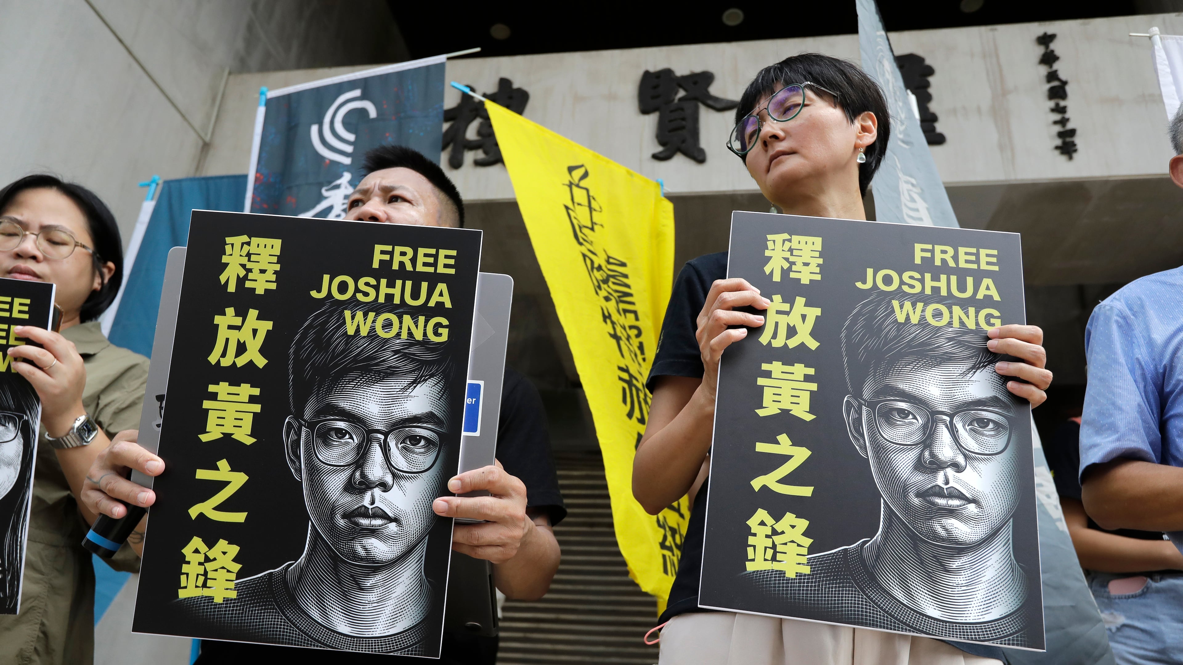 Hong Kong activist and supporters hold signs during a press event to support pro-democracy activist Joshua Wong in Taipei, Taiwan, Wednesday, Sept. 2, 2026. (AP Photo/Chiang Ying-ying)
