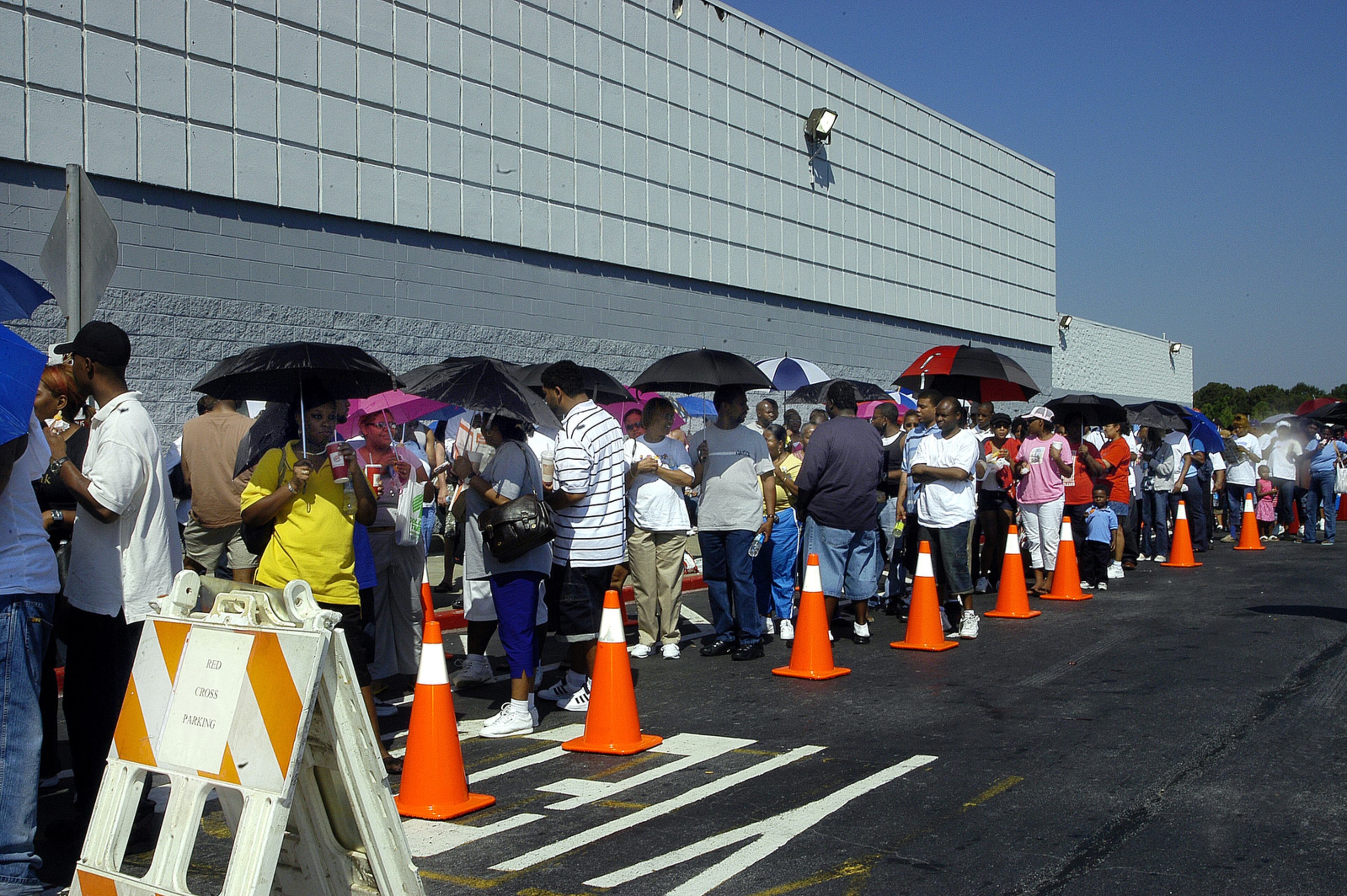 050909 - LAWRENCEVILLE, GA -- Despite the heat, hundreds of Hurricane Katrina evacuees gathered Friday, September 9, 2005 at the new Red Cross supercenter in Lawrenceville. These individuals are waiting in line to register with the Red Cross and get a ticket. At that point, an appointment will be set for next week to come back and meet with a caseworker. (Sarah Ianacone/Special)