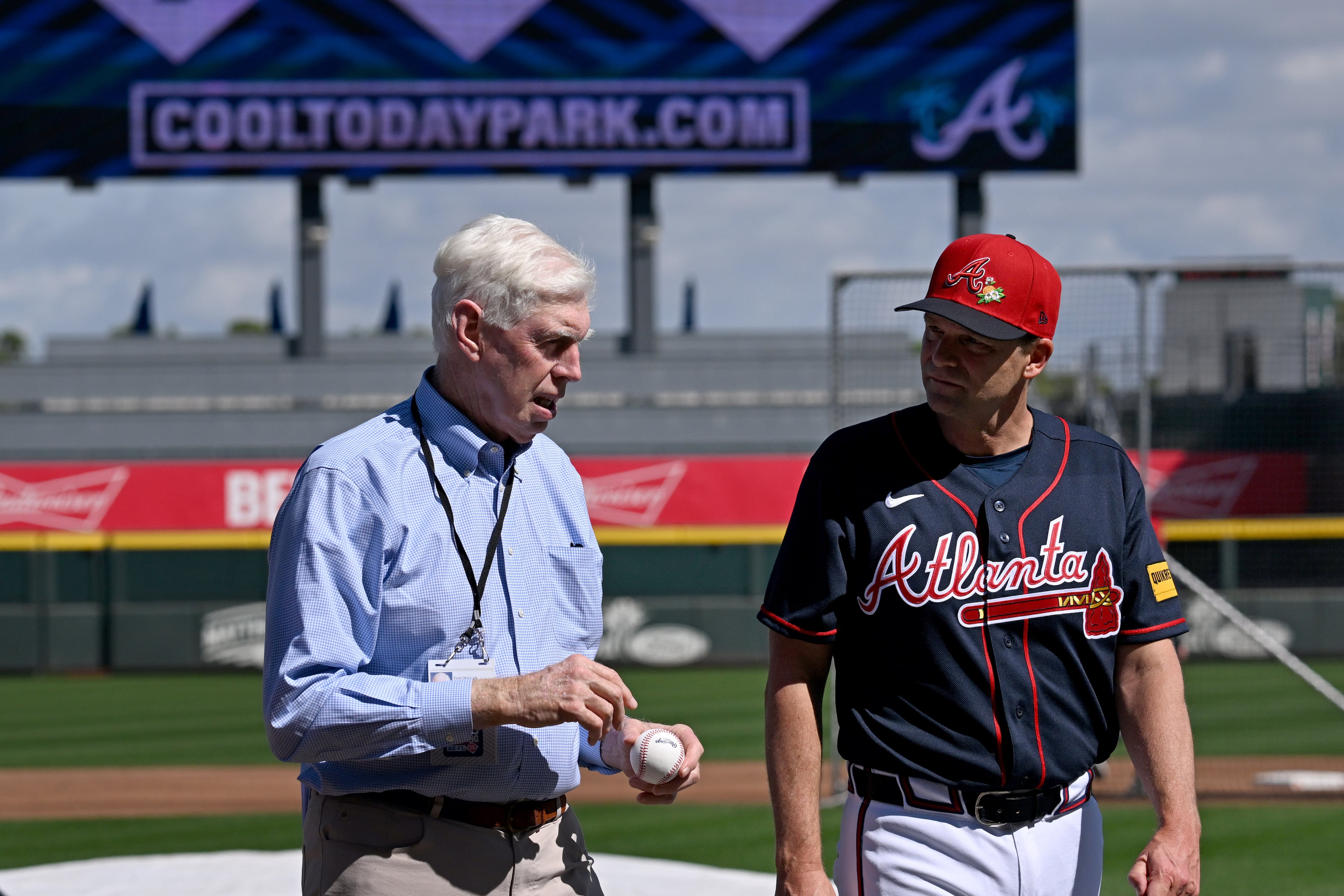 Terry McGuirk (left), chairman of the Atlanta Braves, chats with hitting coach Tim Hyers during the first full-squad spring training workouts at CoolToday Park on Sunday, Feb. 15, 2026, in North Port, Fla. (Hyosub Shin/AJC)