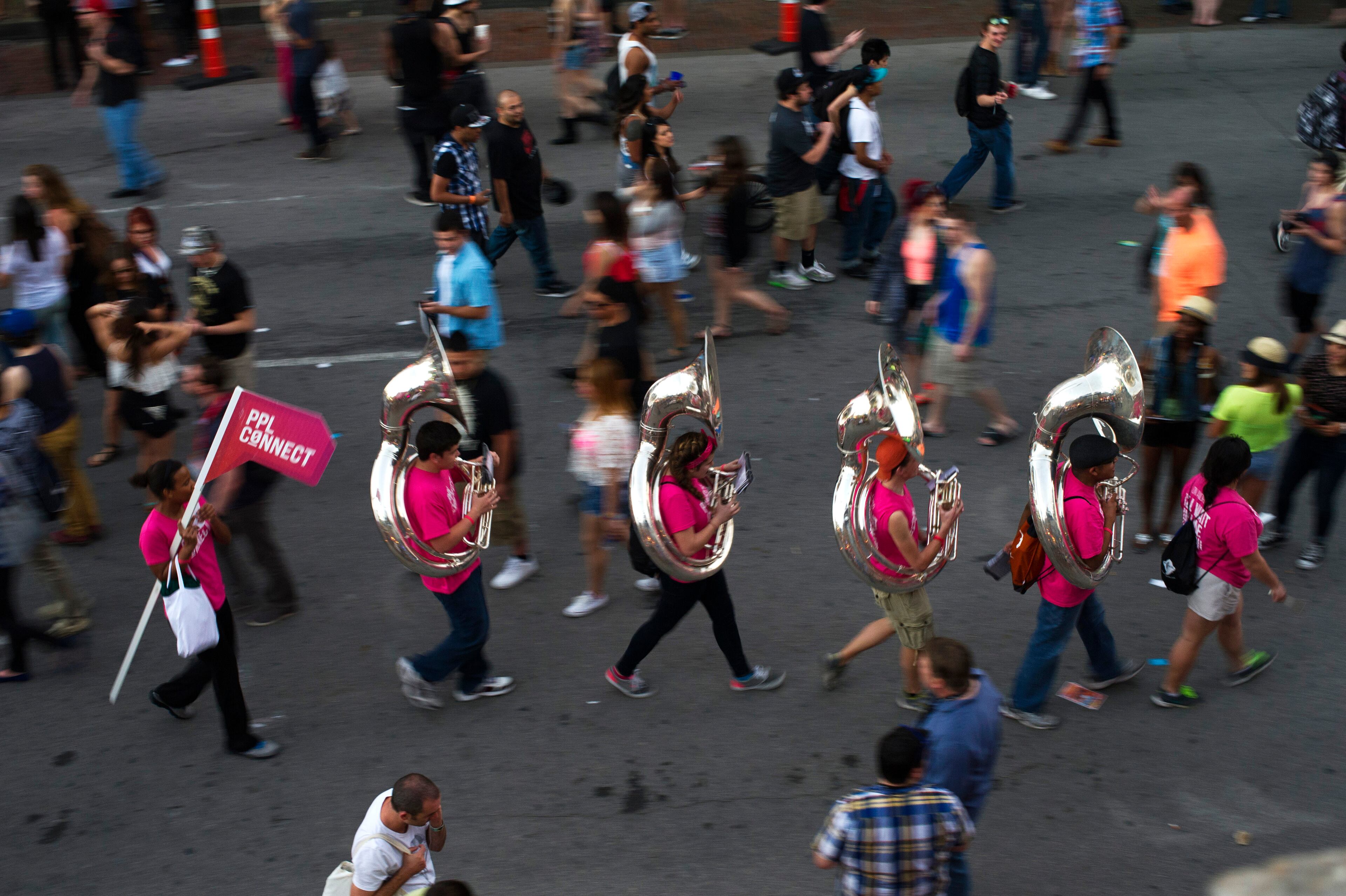 Musicians promoting Pplconnect Inc. play music as they walk down 6th Street at the South By Southwest (SXSW) Interactive Festival in Austin, Texas, U.S., on Tuesday, March 11, 2014. The SXSW conferences and festivals converge original music, independent films, and emerging technologies while fostering creative and professional growth. Photographer: David Paul Morris/Bloomberg