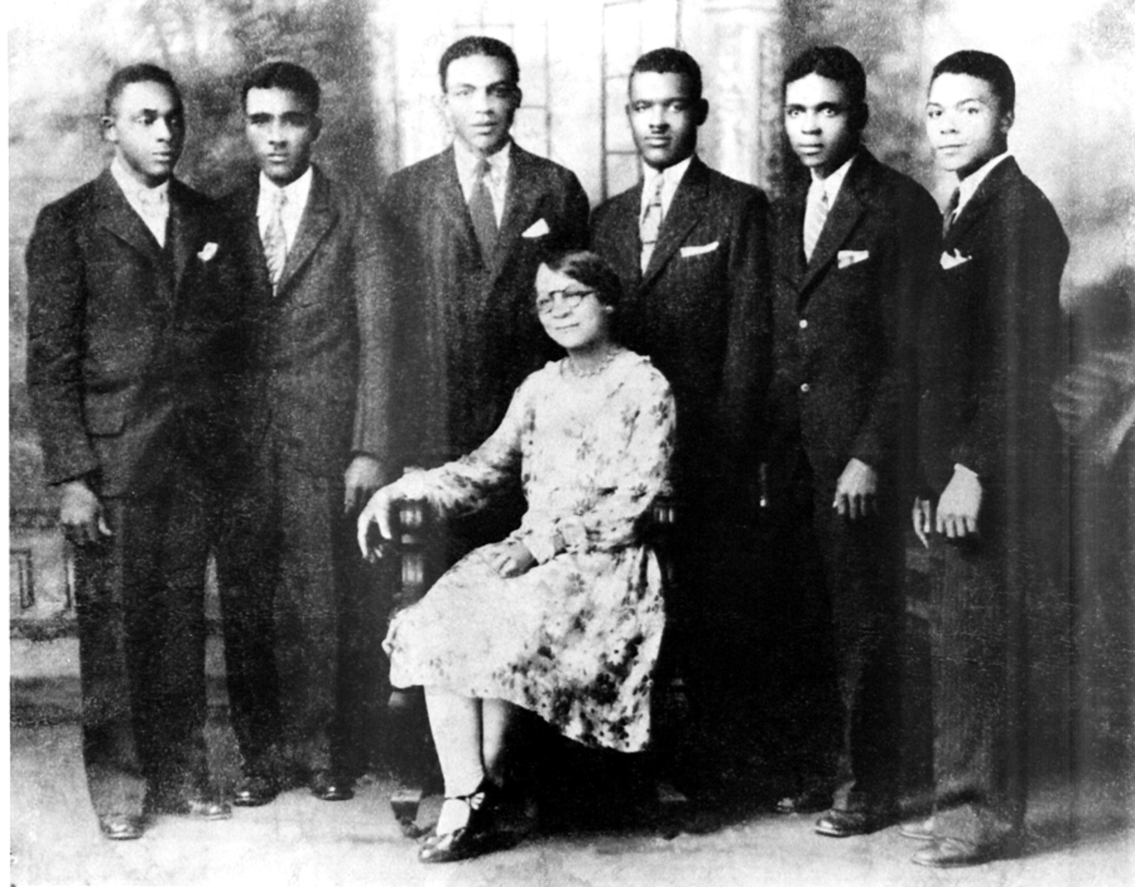 Emmeline Southhall Scott (center) is shown surrounded by her sons in a family photograph taken near the time the Atlanta Daily World was founded in 1928. They are (from left) Emel Julius, Aurelius Southall, Lewis Augustus, William Alexander II, Cornelius Adolphous (C.A.), and Daniel Marcellus. The first generation of Atlanta Daily World Scotts also included three daughters. Emmeline Southhall Scott worked for the paper for years and actually introduced her sons to printing.