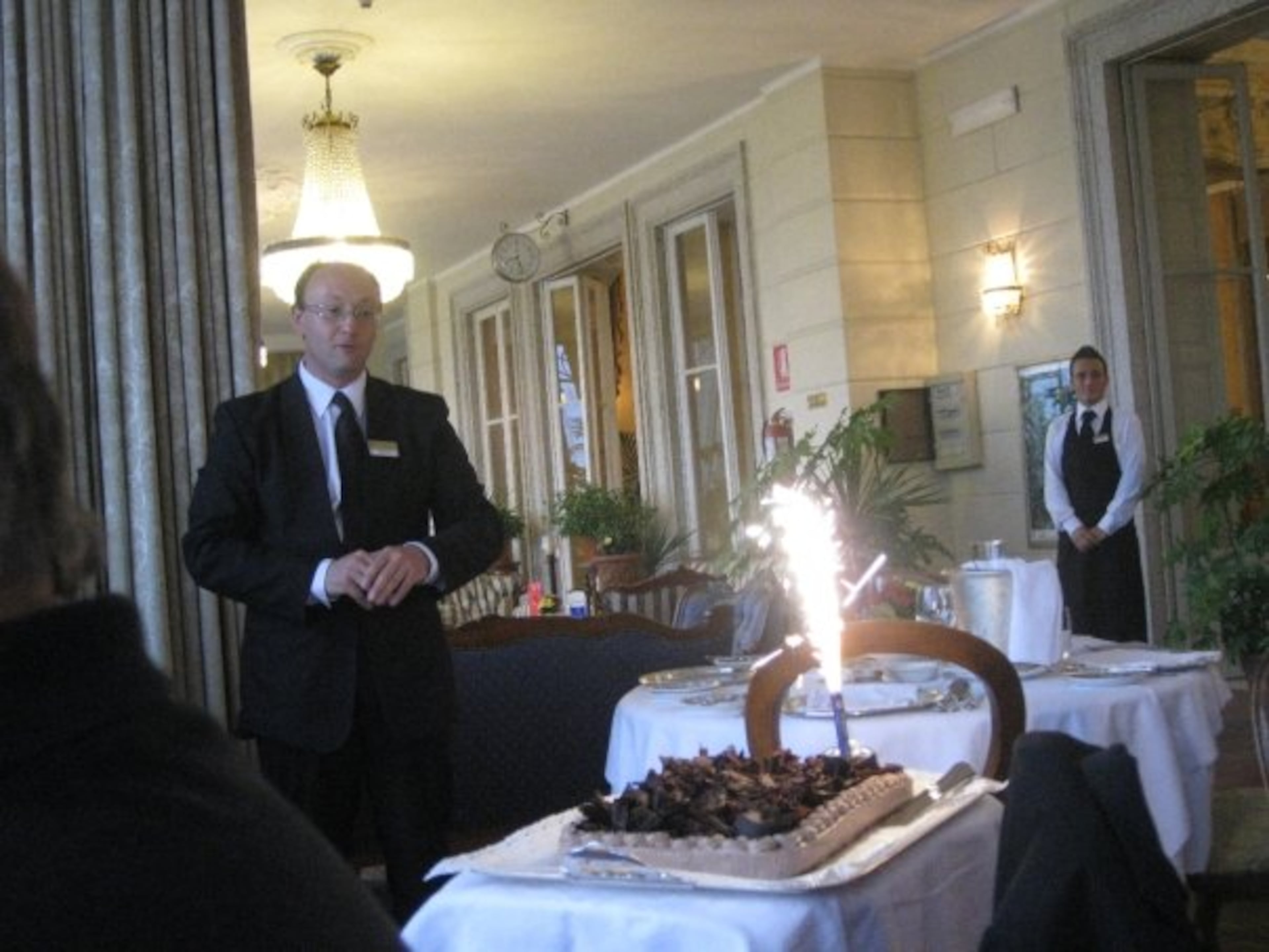 A head server named Roberto wheels out a birthday cake for writer Bill King’s son at the Lido Palace Hotel on the shore of Lake Maggiore in Baveno, Italy. (Courtesy of the King family)