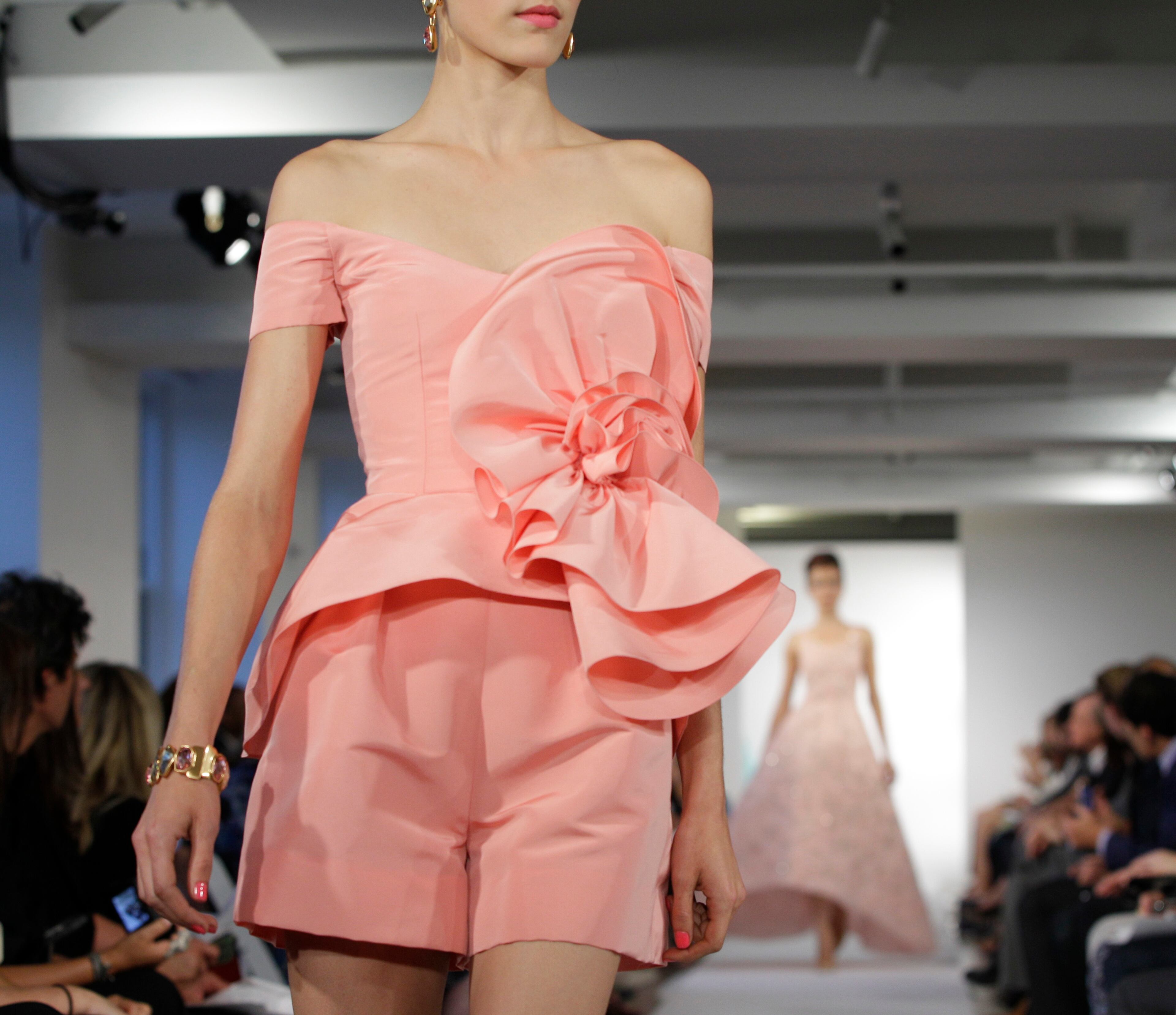 In this Sept. 11, 2012, file photo, a model walks the runway during the presentation of the Oscar de la Renta Spring 2013 collection at Fashion Week in New York. The designer, who died Monday, Oct. 20, 2014, at 82, shaped American couture half a century ago when it emerged as a serious rival to European fashion designers. (AP Photo/Kathy Willens, File)