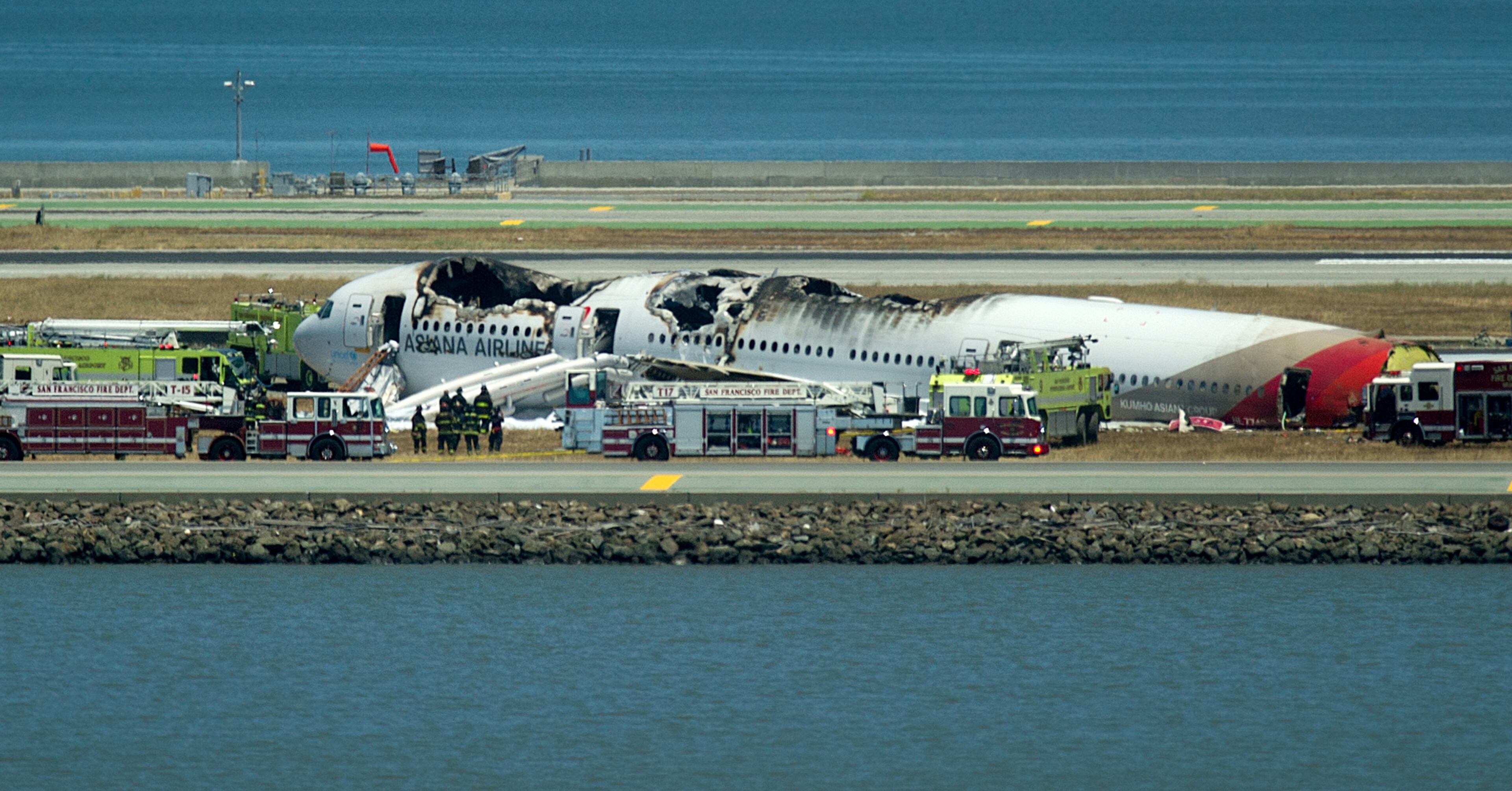 A fire truck sprays water on Asiana Flight 214 after it crashed at San Francisco International Airport on Saturday, July 6, 2013, in San Francisco. (AP Photo/Noah Berger)