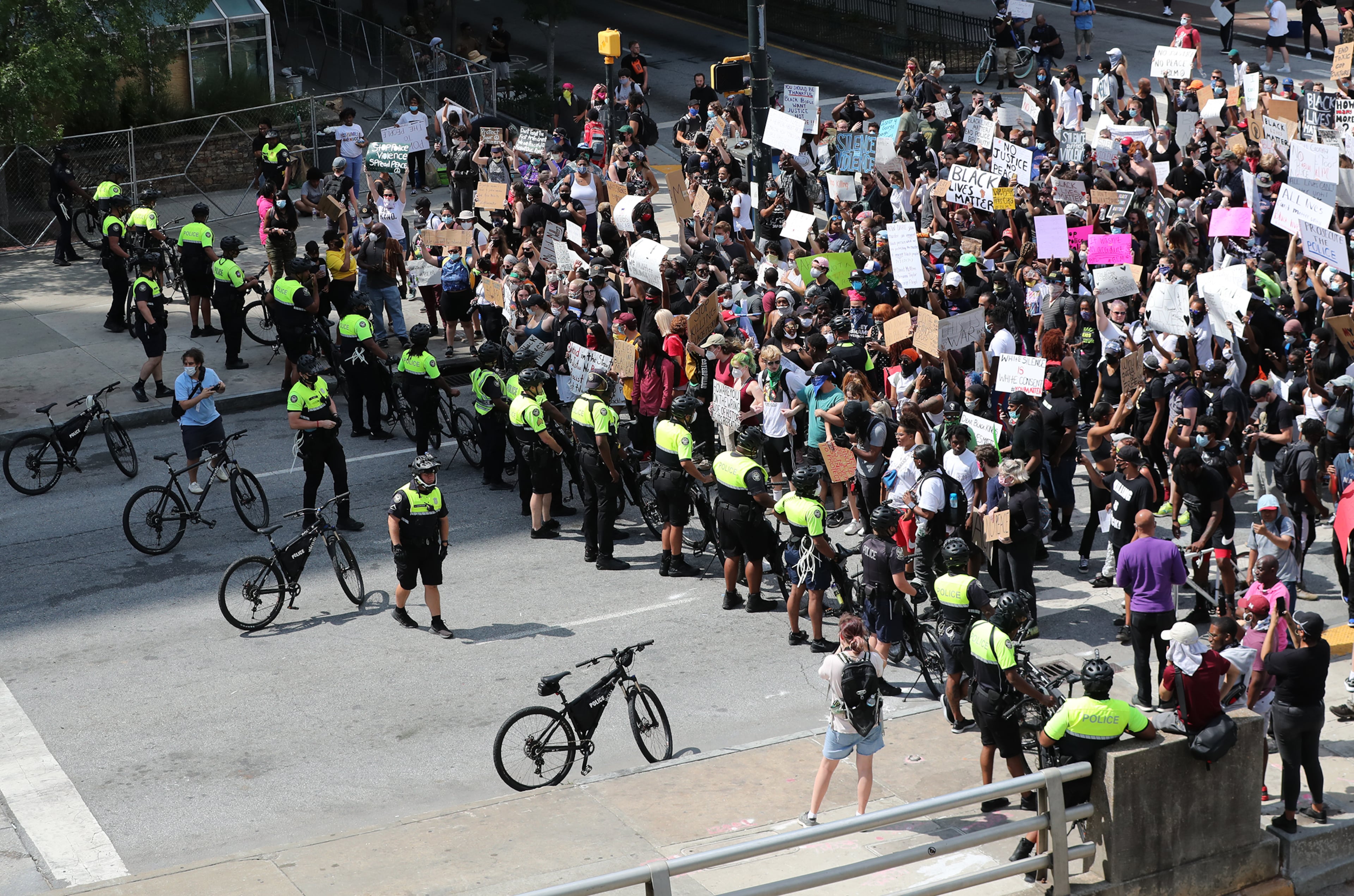 060220 Atlanta: Starting with a softer approach a Atlanta Police bycycle unit blocks the street in front of protesters outside the CNN Center at Olympic Park during a fifth day of protests over the death of George Floyd on Tuesday, June 2, 2020, in Atlanta. Curtis Compton ccompton@ajc.com