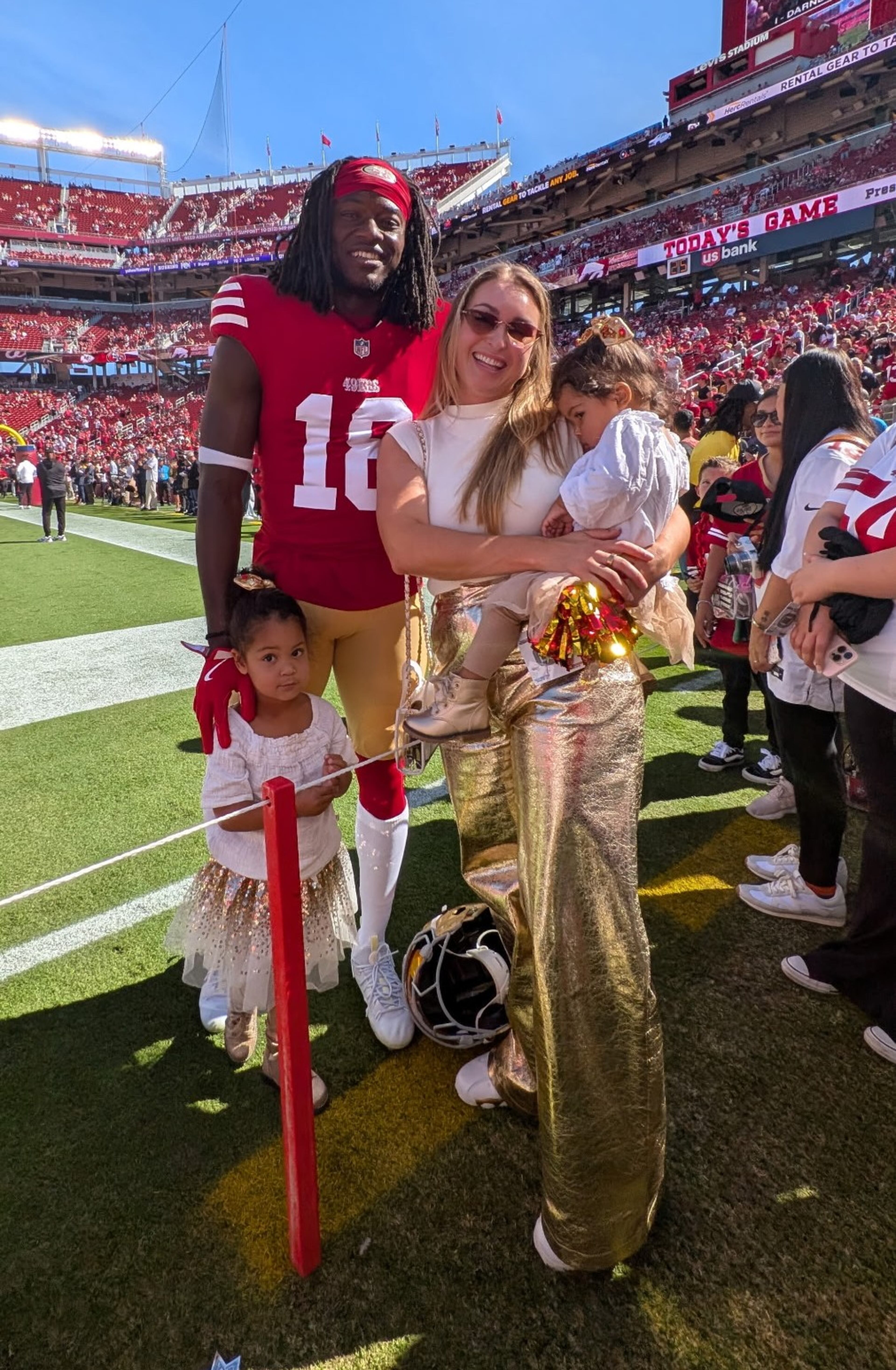 Former Georgia wide receiver Chris Conley stands with his wife, Brianna, and daughters Calani (standing) and Caia before a San Francisco 49ers game at Levi's Stadium in Santa Clara, Calif. Conley played for the 49ers in the 2023 and 2024 seasons before retiring. (Courtesy of Chris Conley)