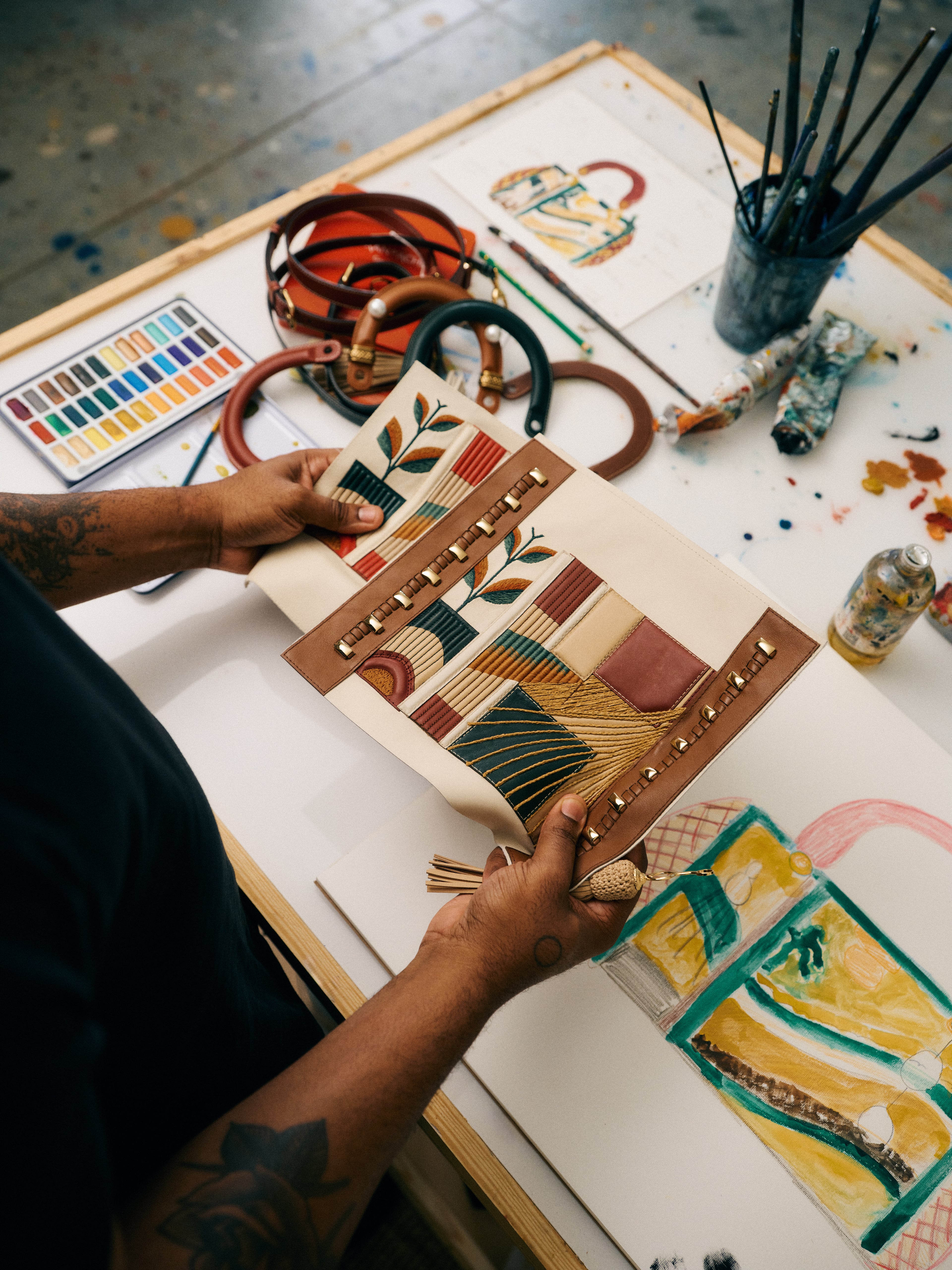 Patrick Eugène reviews material samples provided by Dior to build his handbag designs as part of the 10th annual Dior Lady Art project. (Courtesy of Heather Sten)