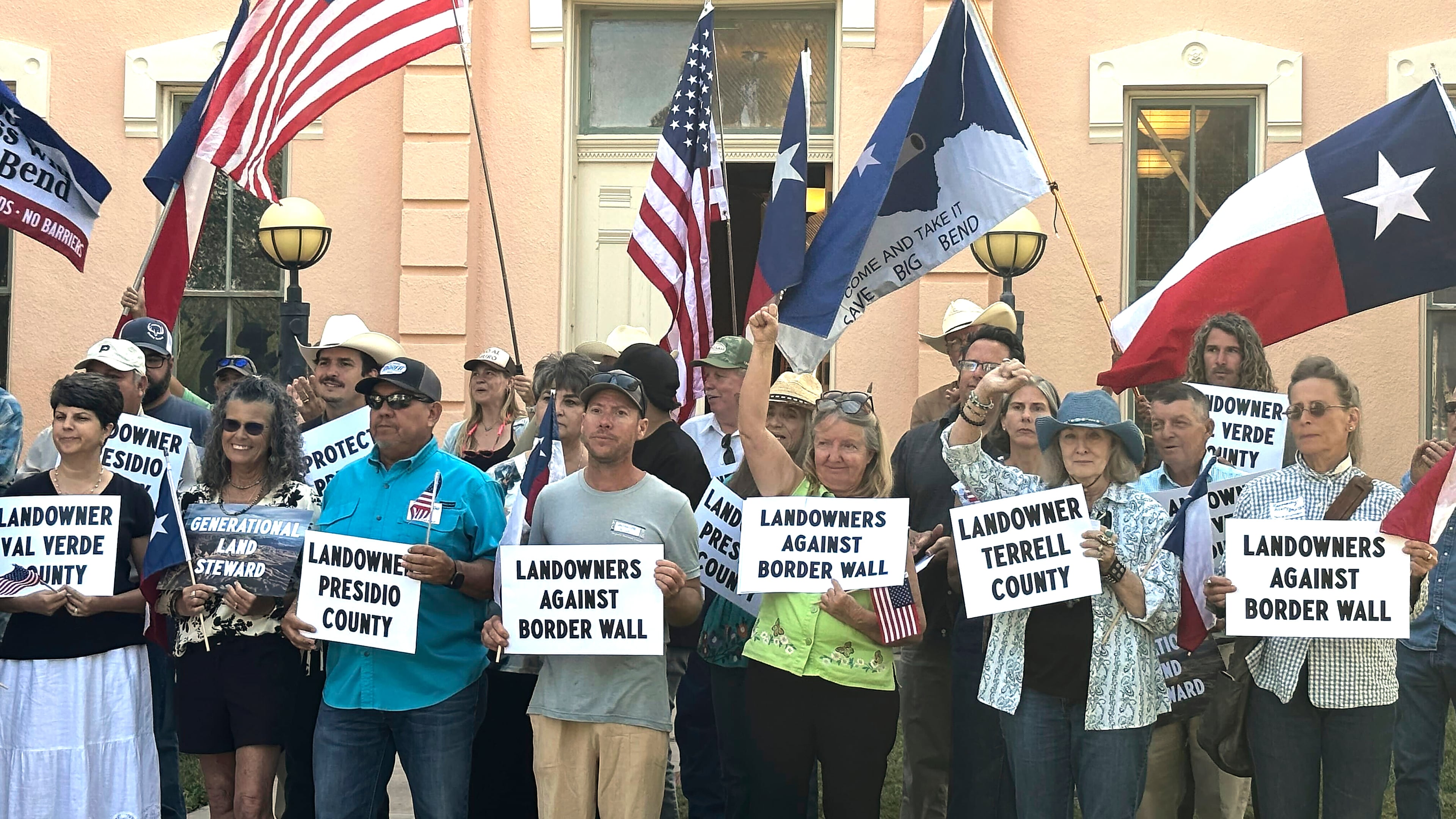 Landowners and other supporters hold signs against the Trump administration's plans to build a border wall and other infrastructure in Texas' remote Big Bend region, Monday, Sept. 14, 2026, in Marfa, Texas. (AP Photo/Rebecca Santana)