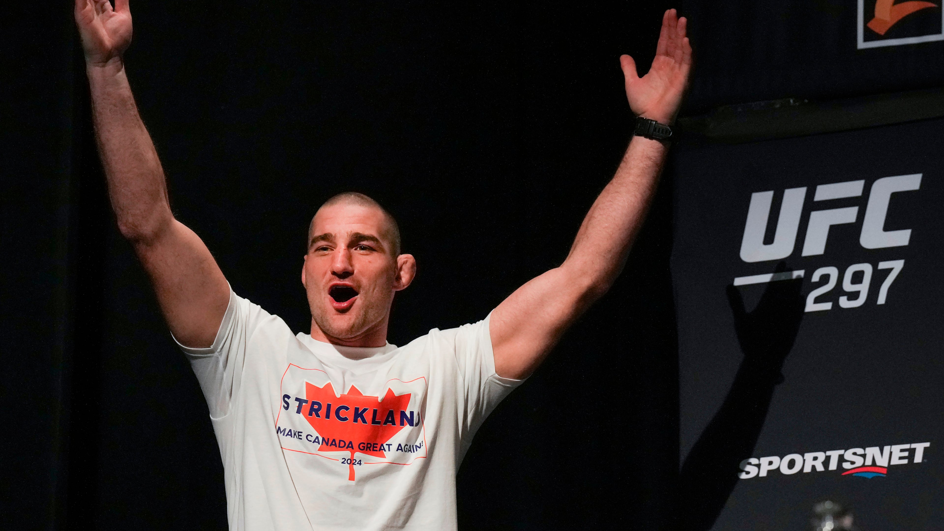 FILE - Sean Strickland, UFC middleweight champion, arrives on stage to face off with Dricus Du Plessis during a mixed martial arts news conference ahead of UFC 297 in Toronto, Thursday, Jan. 18, 2024. (Nathan Denette/The Canadian Press via AP, FIle)