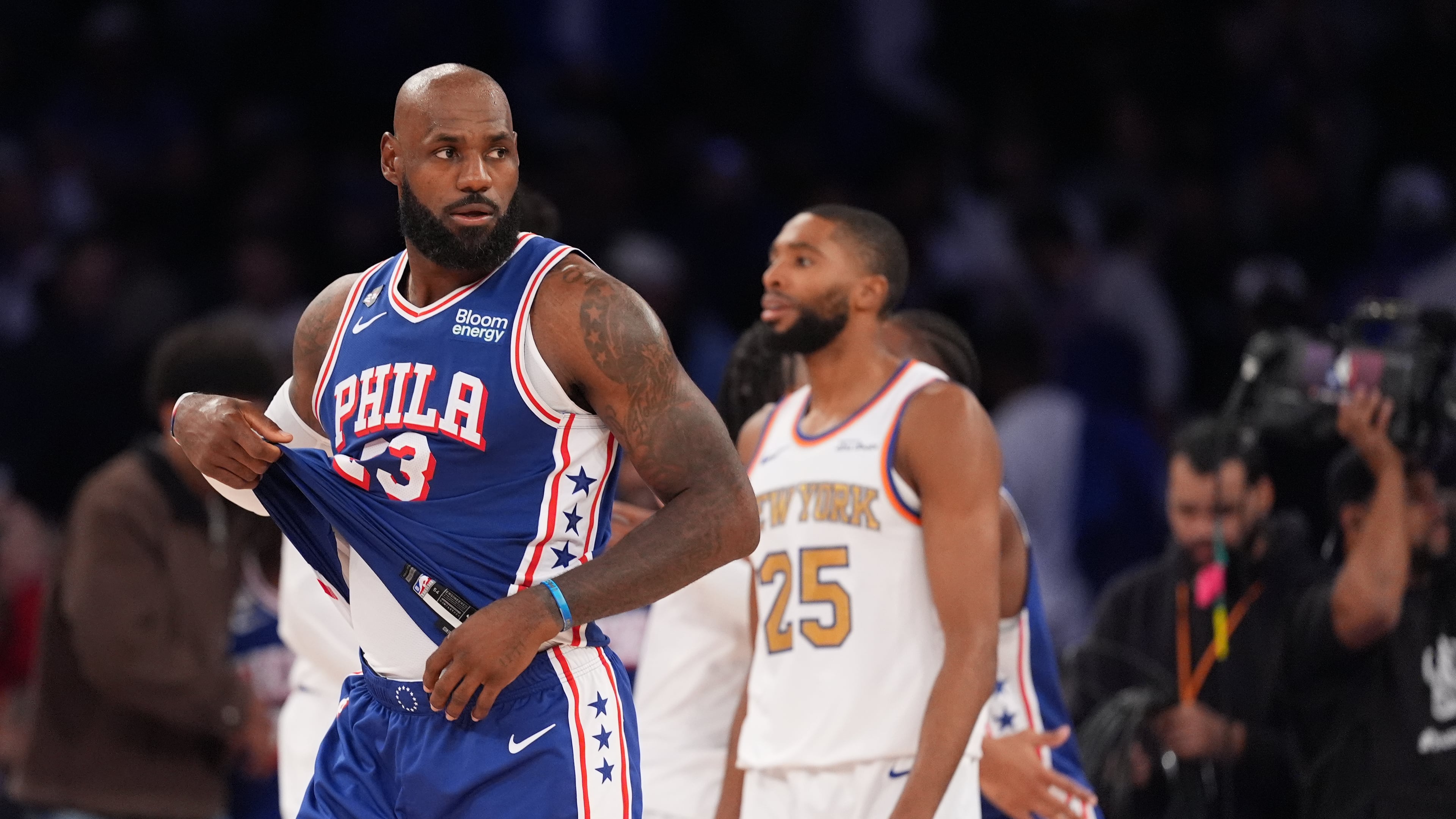 Philadelphia 76ers forward LeBron James, left, passes New York Knicks guard Mikal Bridges after the 76ers defeated the Knicks 106-100 in an NBA basketball game Tuesday, Oct. 20, 2026, in New York. (AP Photo/Frank Franklin II)