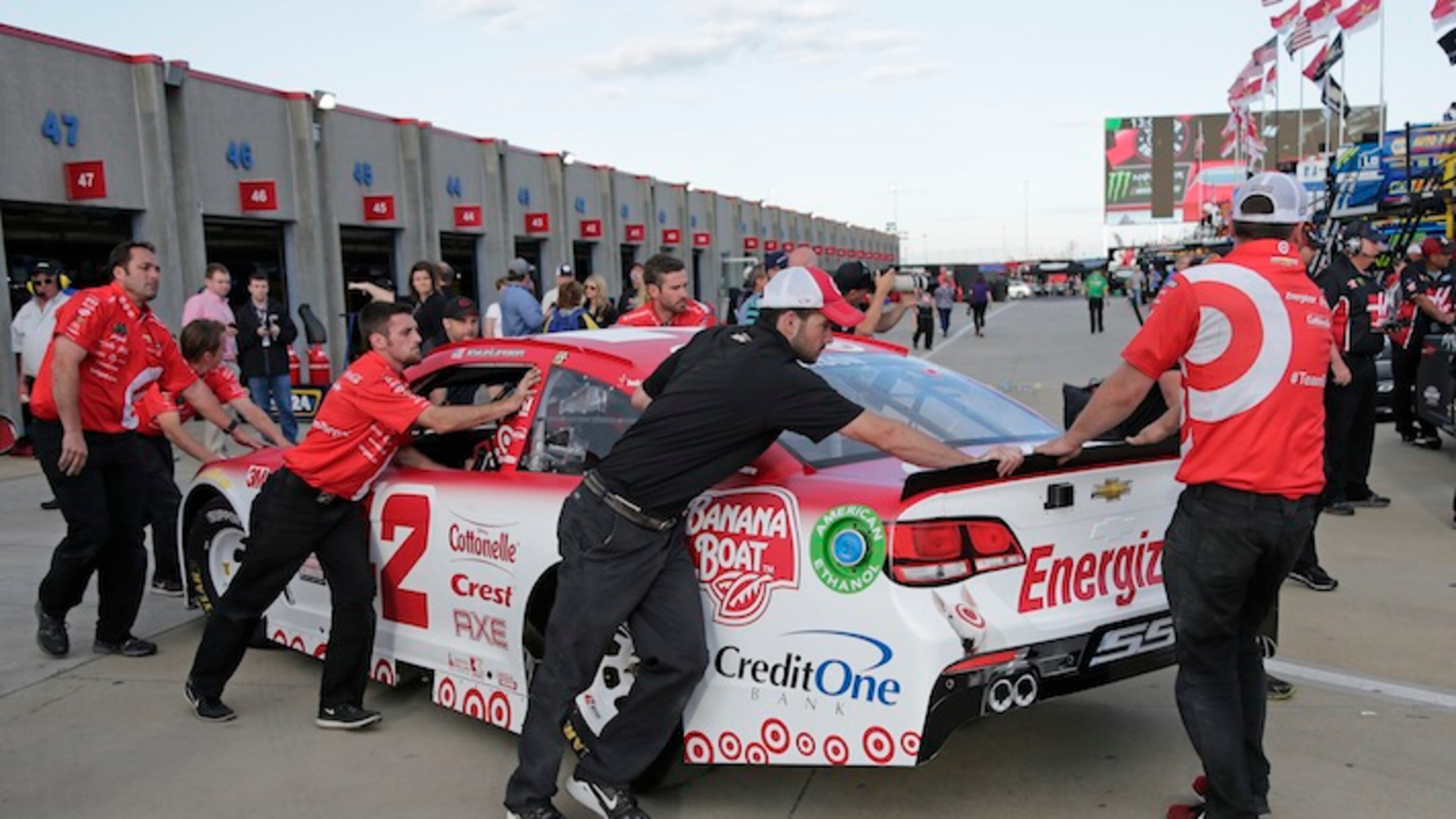 Crew members push Kyle Larson's car from the garage before qualifying for Sunday's NASCAR Cup series auto race at Charlotte Motor Speedway in Concord, N.C., Thursday, May 25, 2017. Larson's car did not pass inspection in time to make qualifying. (AP Photo/Chuck Burton)