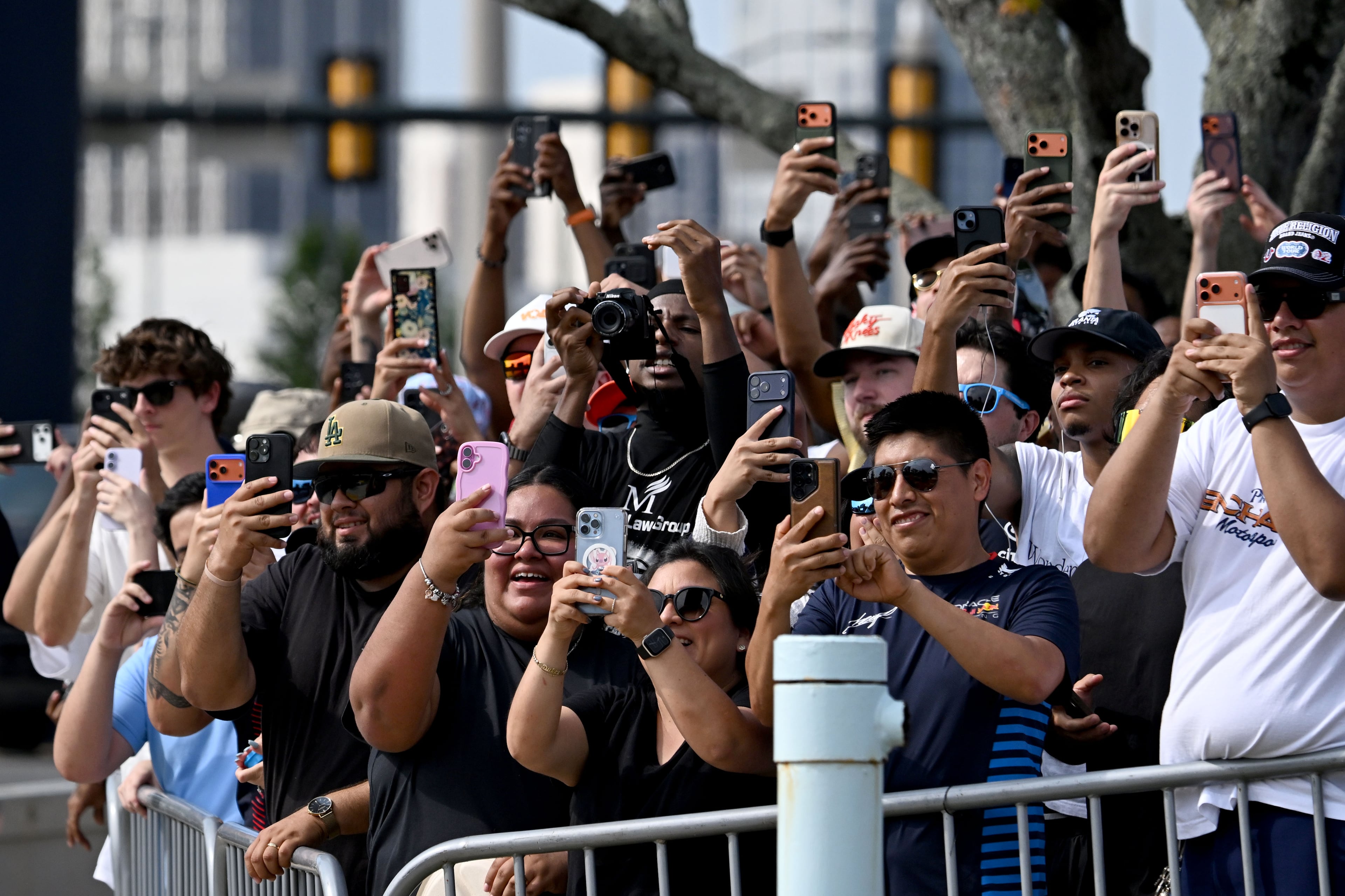 Spectators hold up their smartphones to capture a demonstration run on Hank Aaron Drive during the Red Bull Showrun Atlanta Presented by Ford Racing on Saturday, Aug. 1, 2026, in Atlanta. Atlanta city officials this week approved permits for the Red Bull Showrun that will allow the live motorsports demonstration event to go on as advertised along a roughly half-mile stretch of Hank Aaron Drive — a backup location after earlier plans to hold the event near Piedmont Park ran into opposition from Midtown residents. (Hyosub Shin/AJC)