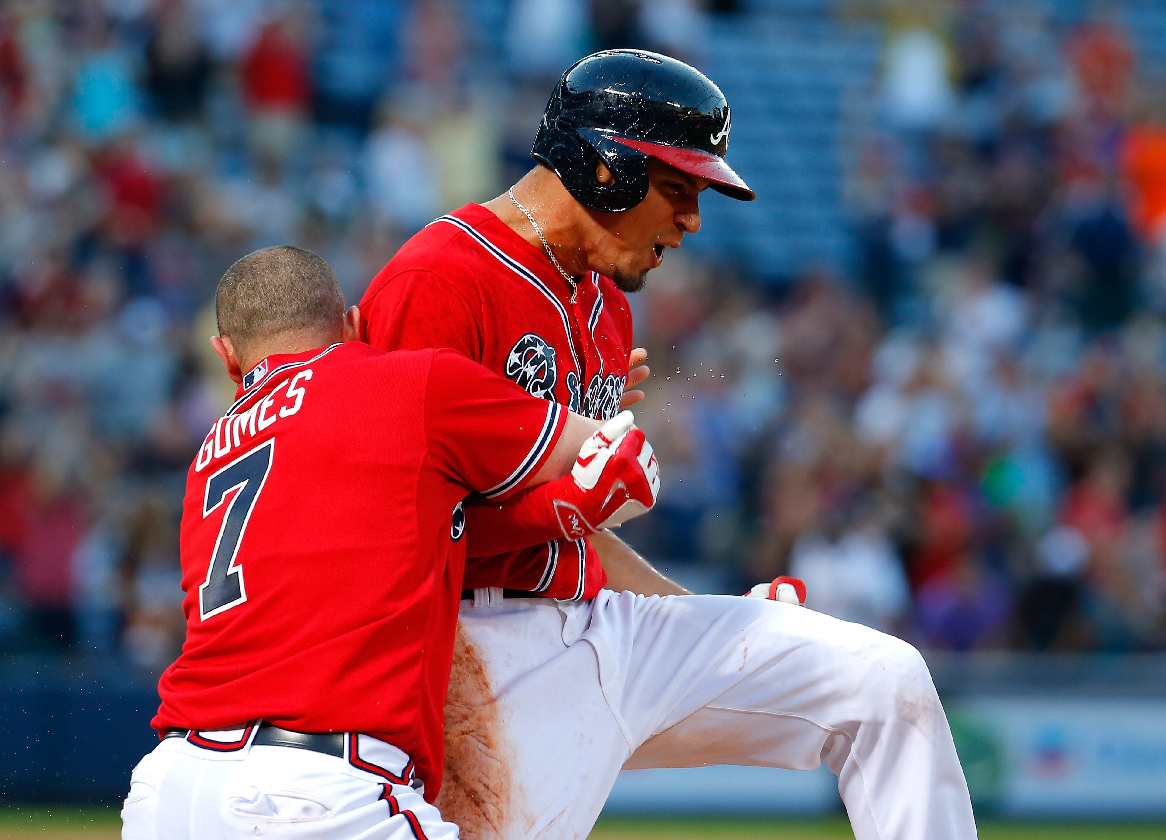Jonny Gomes #7 tackles Jace Peterson #8 of the Atlanta Braves after he hit a walk-off RBI single in the 11th inning against the Milwaukee Brewers at Turner Field on May 23, 2015 in Atlanta, Georgia. The Braves win 3-2. (Photo by Kevin C. Cox/Getty Images)