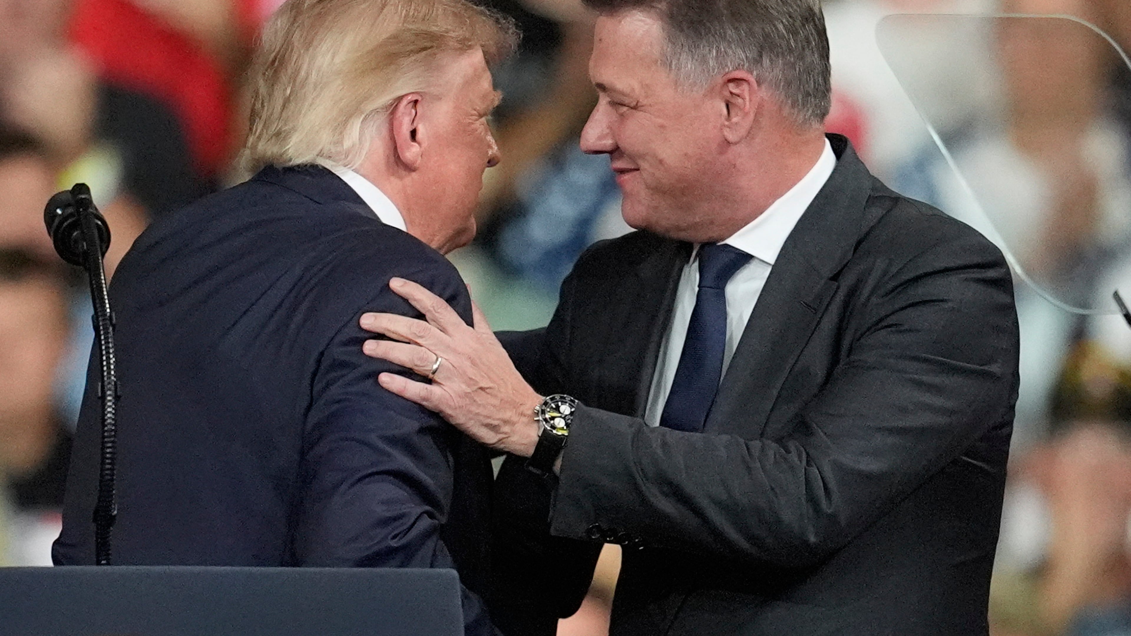President Donald Trump greets Gernot Döllner, CEO of Audi AG, at a campaign rally at Guardian Centers of Georgia, Saturday, Oct. 24, 2026, in Perry, Ga. (A5P Photo/Mike Stewart)