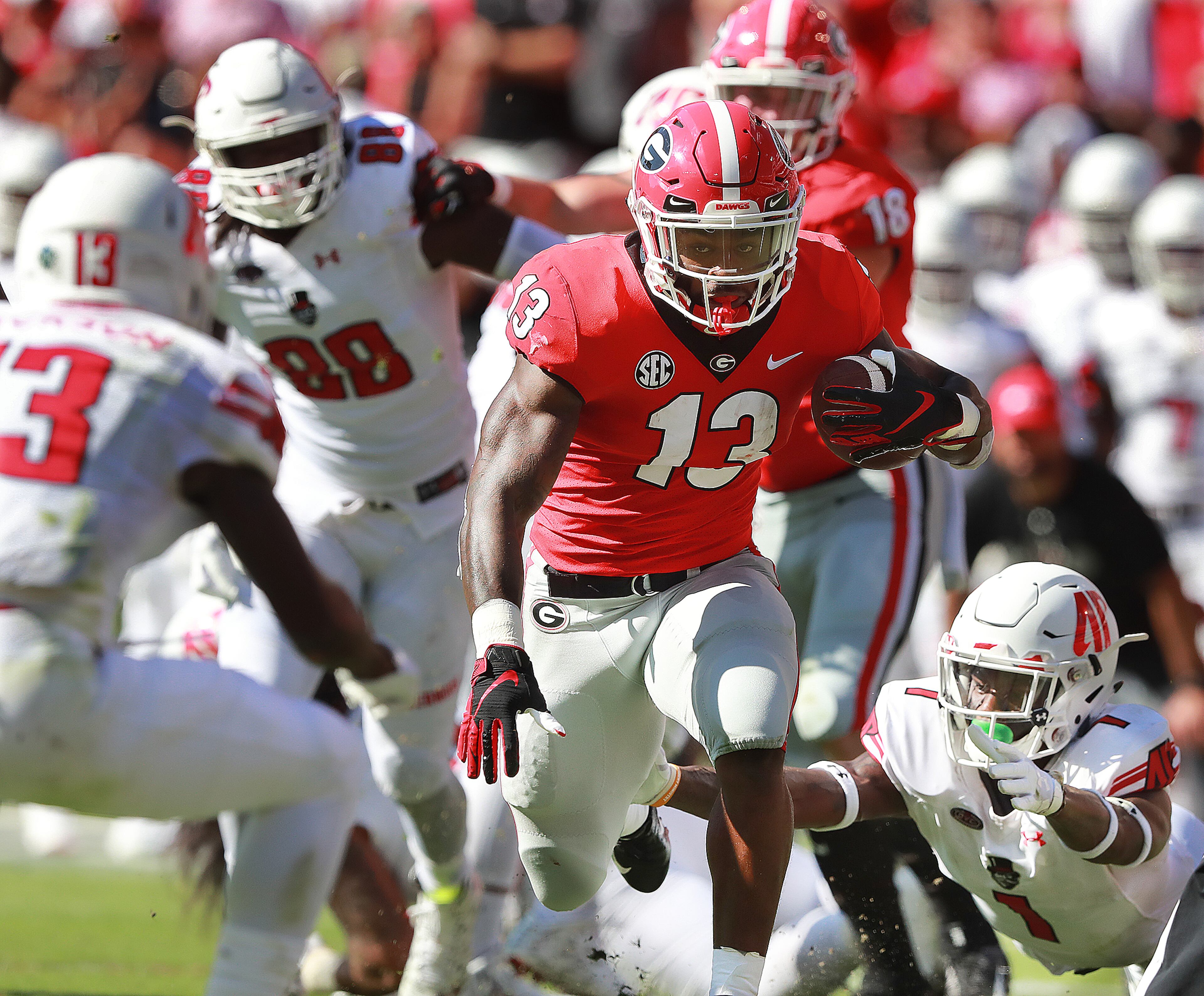 September 1, 2018 Athens: Georgia Bulldogs running back Elijah Holyfield cuts through Austin Peay defenders for a long touchdown run and a 31-0 lead during the second quarter in a NCAA college football game on Saturday, Sept 1, 2018, in Athens. Curtis Compton/ccompton@ajc.com