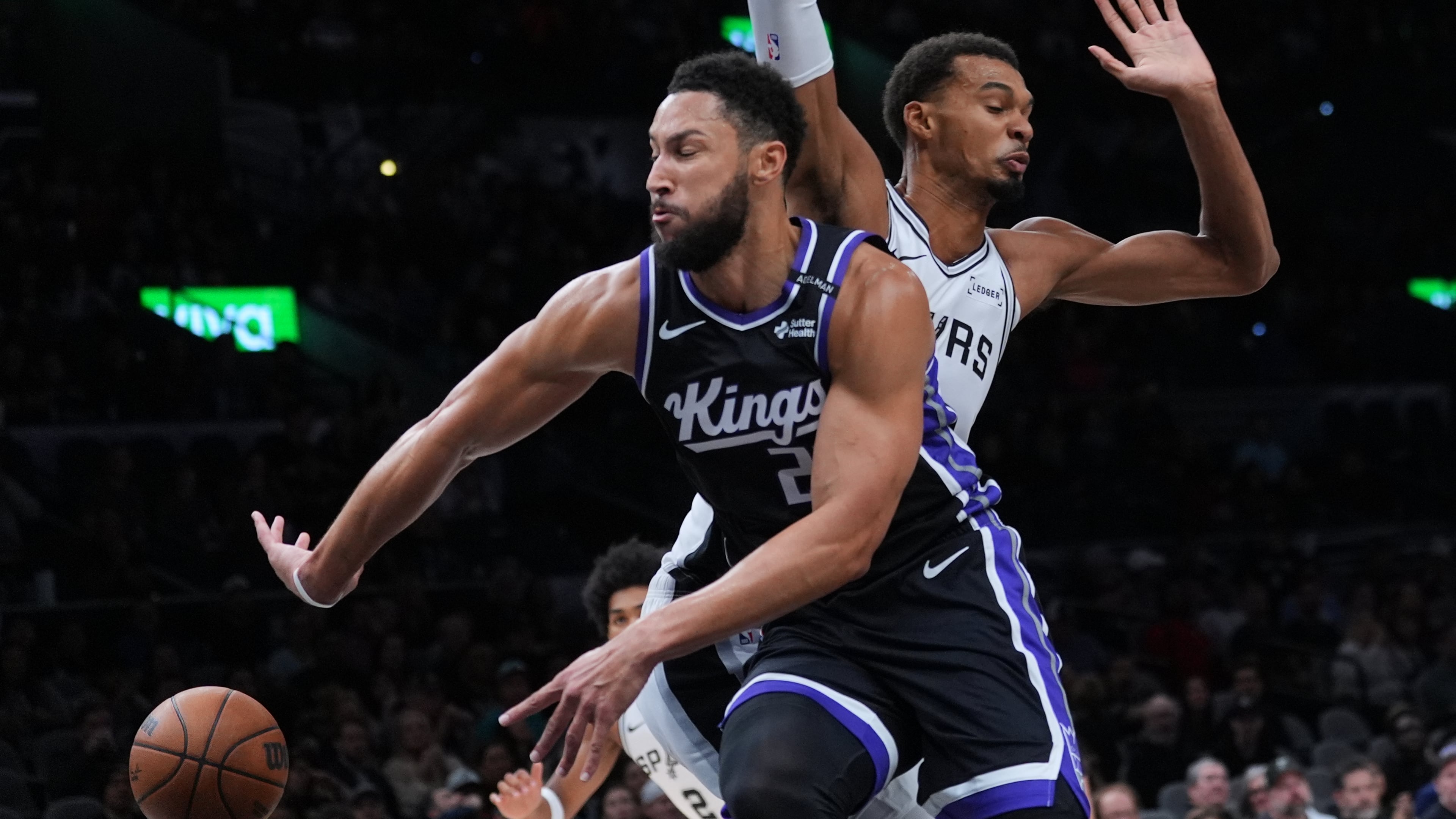 Sacramento Kings guard Ben Simmons (25) drives around San Antonio Spurs forward Victor Wembanyama (1) during the first half of a preseason NBA basketball game in San Antonio, Friday, Oct. 16, 2026. (AP Photo/Eric Gay)