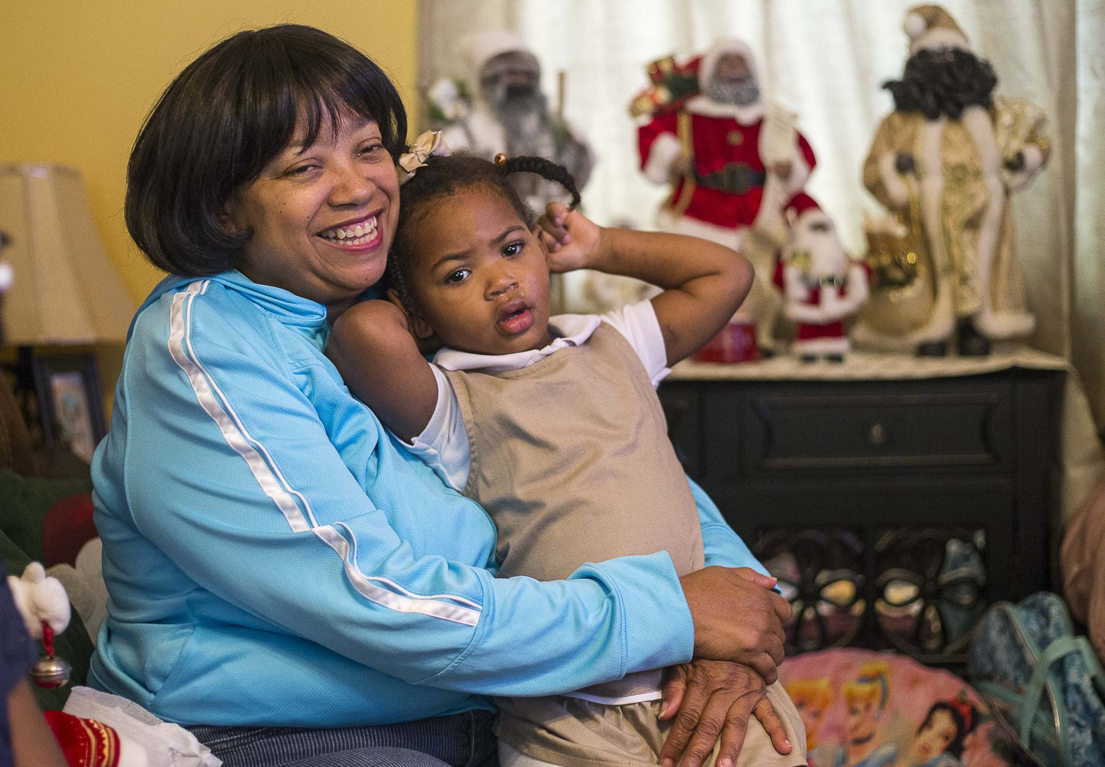 Priscilla Moses, 52, sits with her adopted daughter Karrigan, 2, at their residence in Decatur. Karrigan, who was born to a teenage mom, has been with the Moses sisters since she was 5 days old. They fostered her, then adopted her.