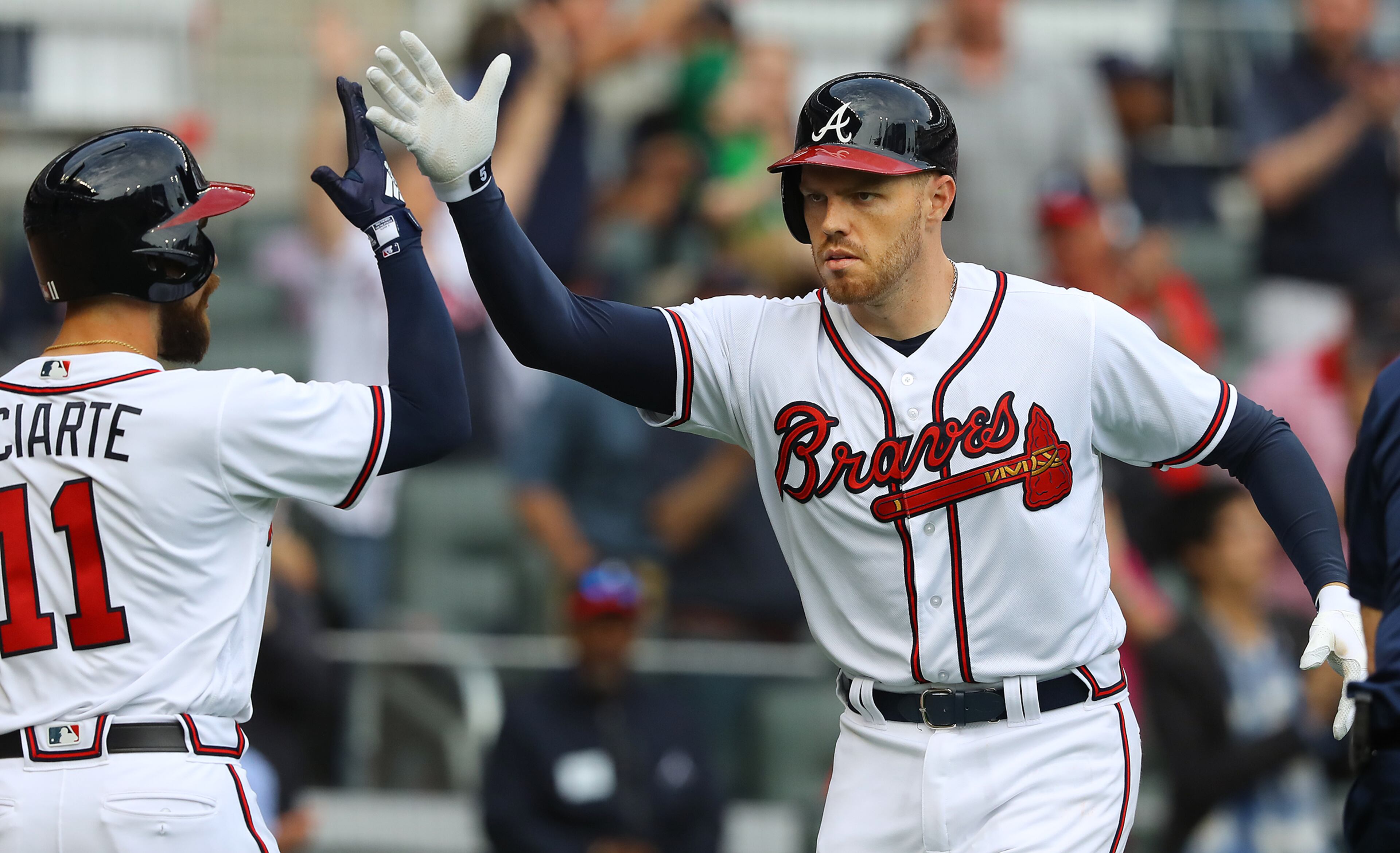 March 29, 2018 Atlanta: Atlanta Braves first baseman Freddie Freeman gets five from Ender Inciarte hitting a 2-run homer against the Phillies during the sixth inning in a MLB baseball home opening game on Thursday, March 29, 2018, in Atlanta. Curtis Compton/ccompton@ajc.com
