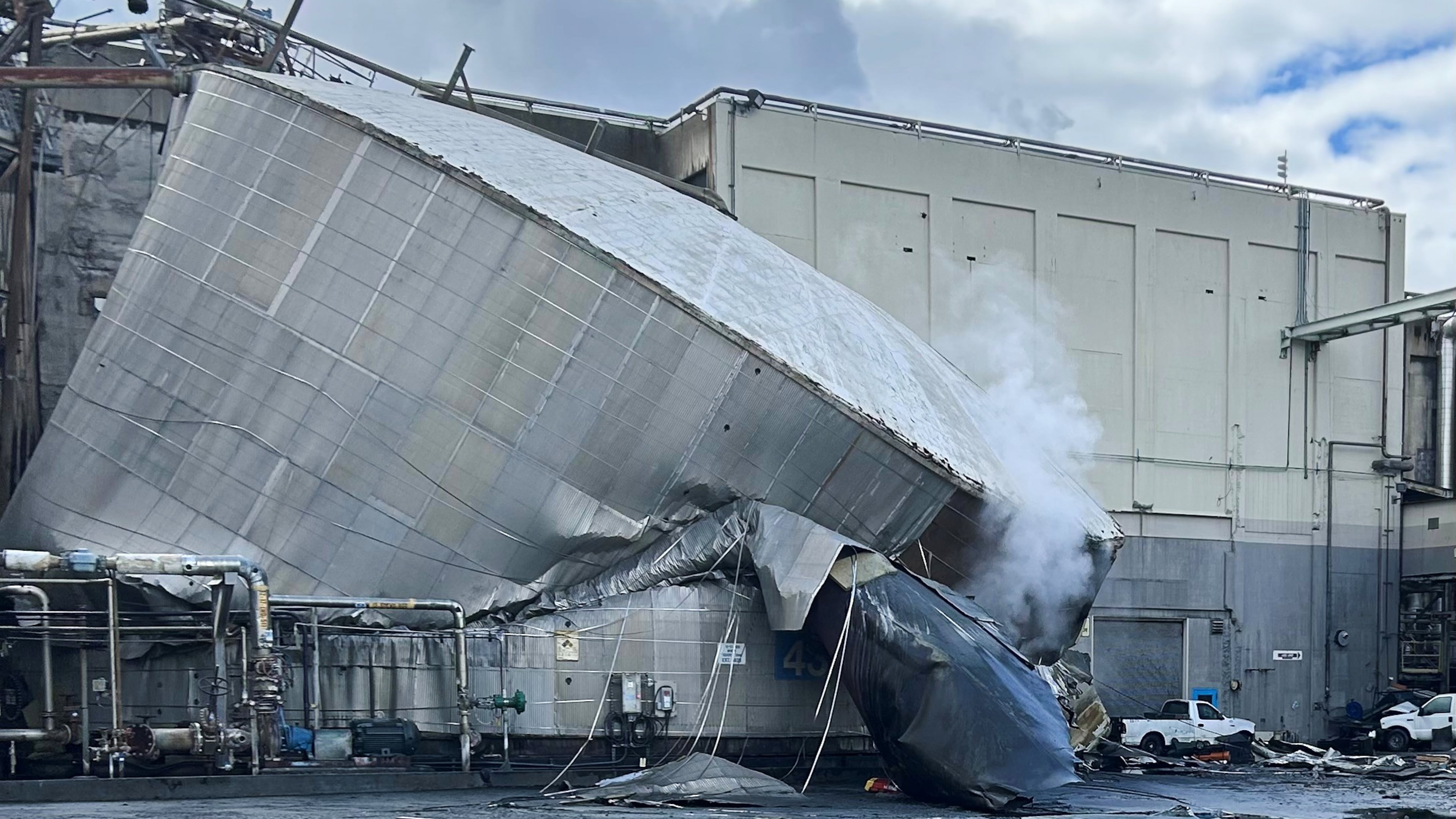 This photo provided by the City of Longview, Wash., shows structural damage to the Nippon Dynawave Packaging Co., after a tank containing hazardous liquid imploded, on Tuesday, May 26, 2026 in Longview, Wash. (City of Longview via AP)