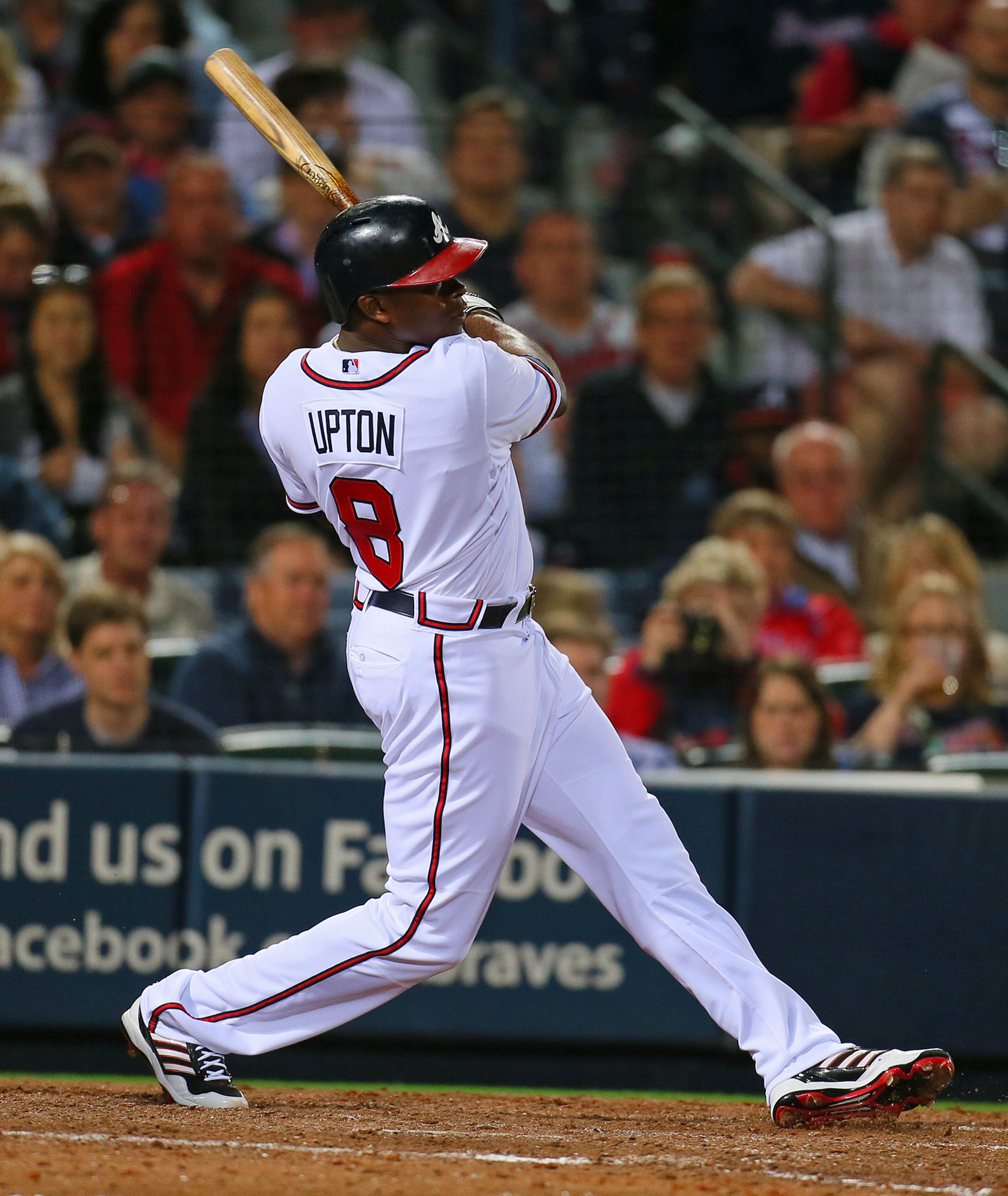 Braves outfielder Justin Upton hits a solo home run off Phillies pitcher Cole Hamels for a 5-3 lead in the fifth inning of the season opener.