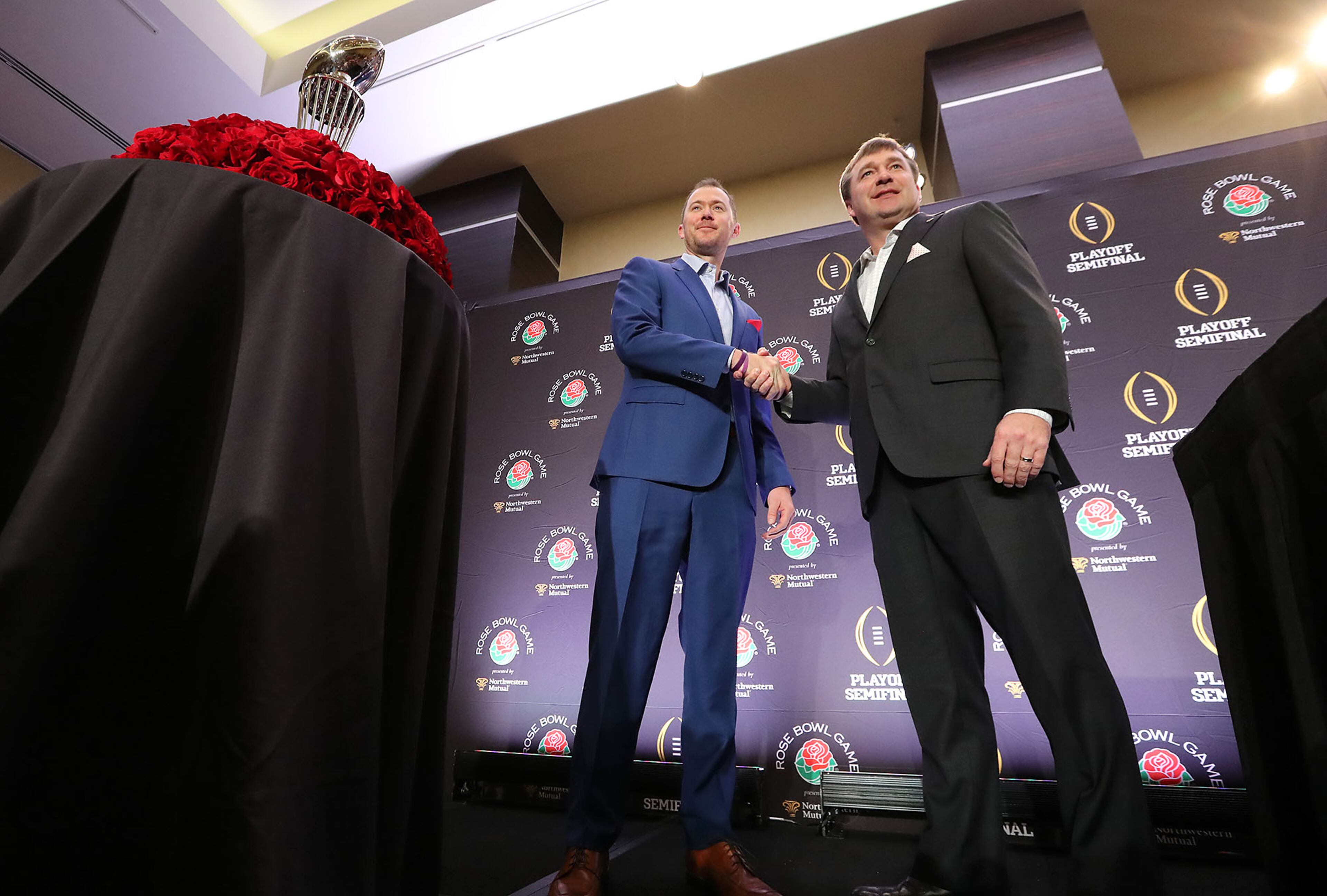 December 31, 2017 Los Angeles: Georgia head coach Kirby Smart and Oklahoma head coach Lincoln Riley shake hands with the Rose Bowl trophy at the conclusion of the head coach press conference on Sunday, December 31, 2017, in Los Angeles. Curtis Compton/ccompton@ajc.com