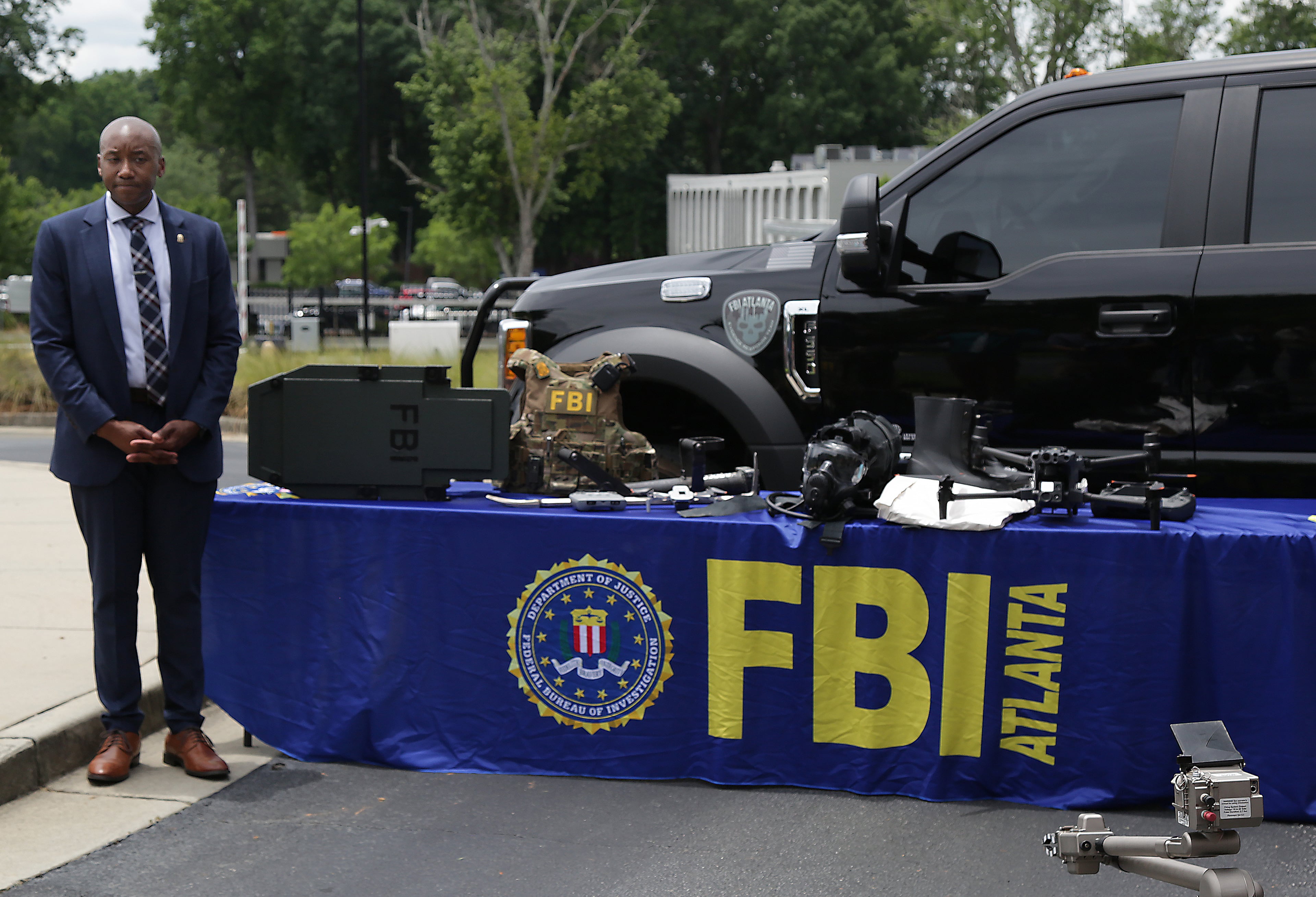 Aaron Hope, FBI Atlanta Supervisory Special Agent-Crisis Response Squad, shows a display of drones and other security gear the FBI may utilize during the 2026 FIFA World Cup in Atlanta. (Akili-Casundria Ramsess for the AJC)