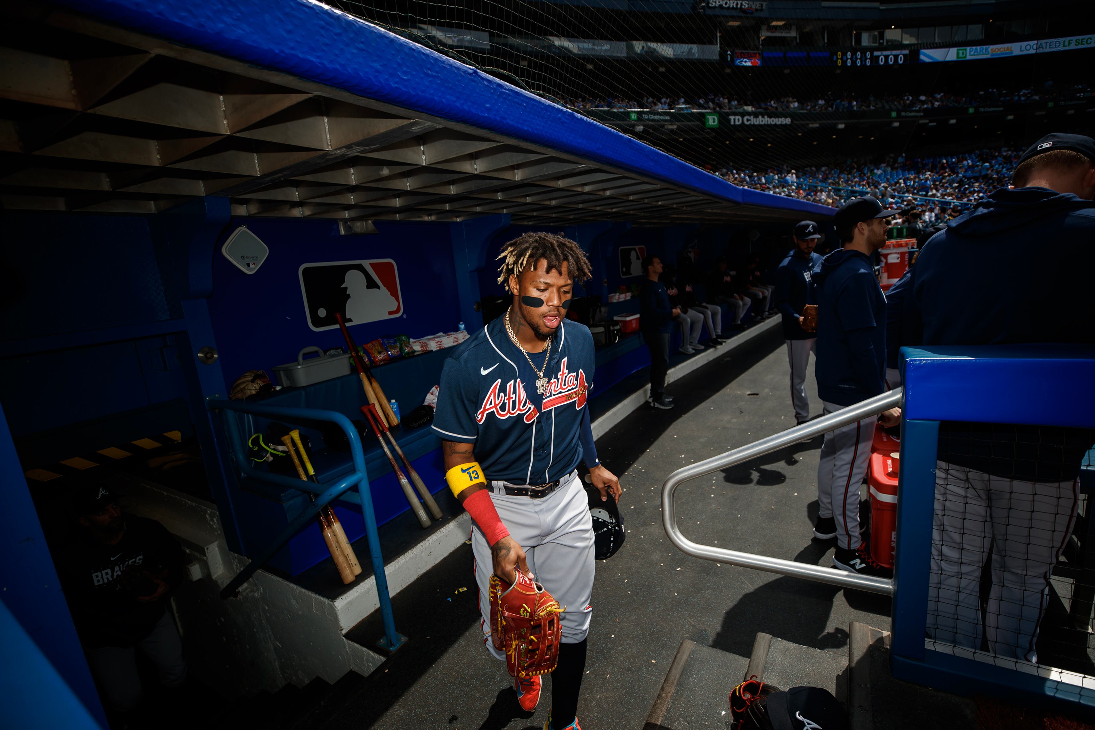 Atlanta Braves outfielder Ronald Acuna Jr. grabs his glove as he takes the field against the Toronto Blue Jays at Rogers Centre on Saturday, May 13, 2023, in Toronto. (Cole Burston/Getty Images/TNS)