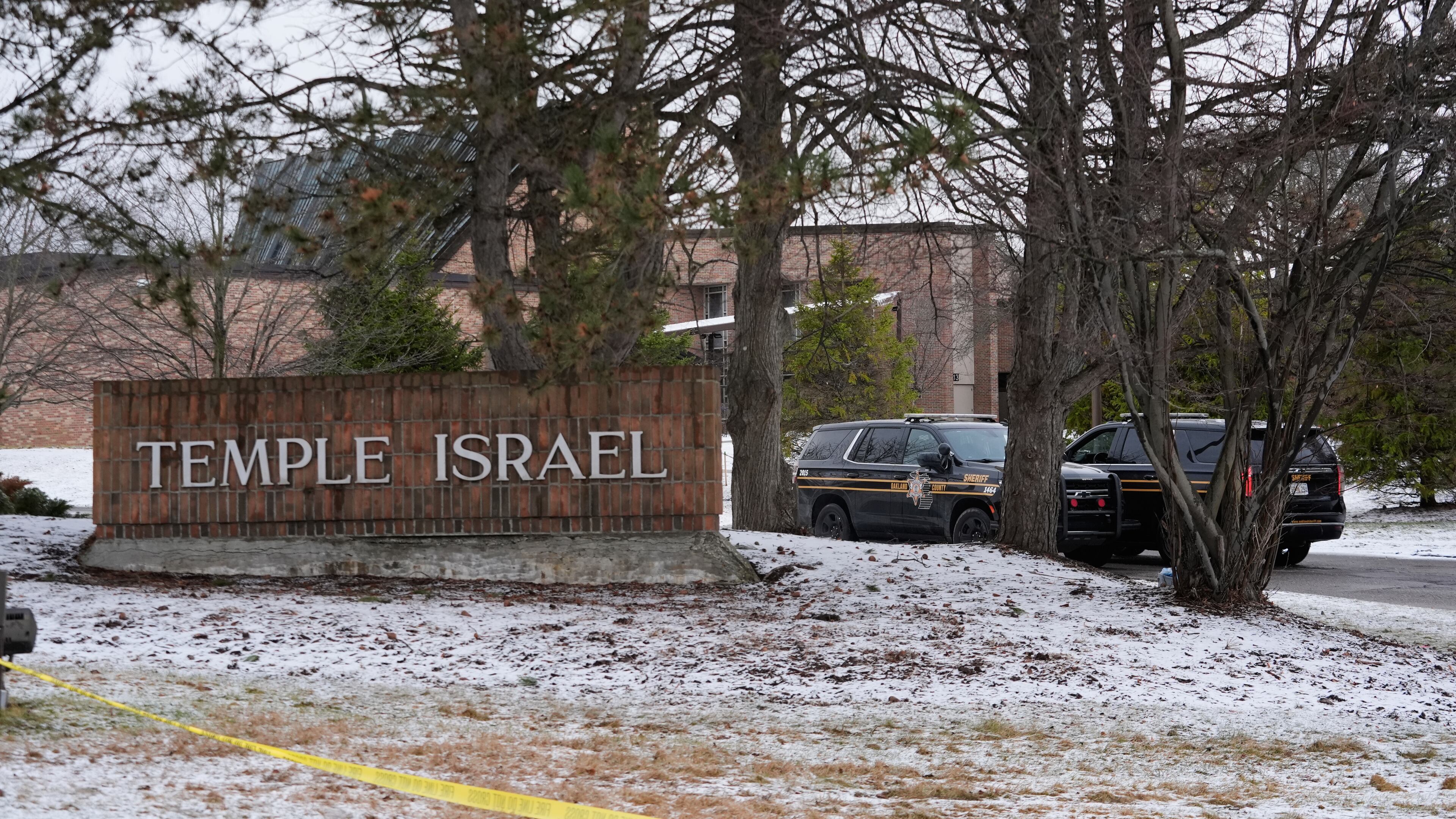 Police vehicles sit outside the Temple Israel synagogue Friday, March 13, 2026, in West Bloomfield Township, Mich. (AP Photo/Paul Sancya)