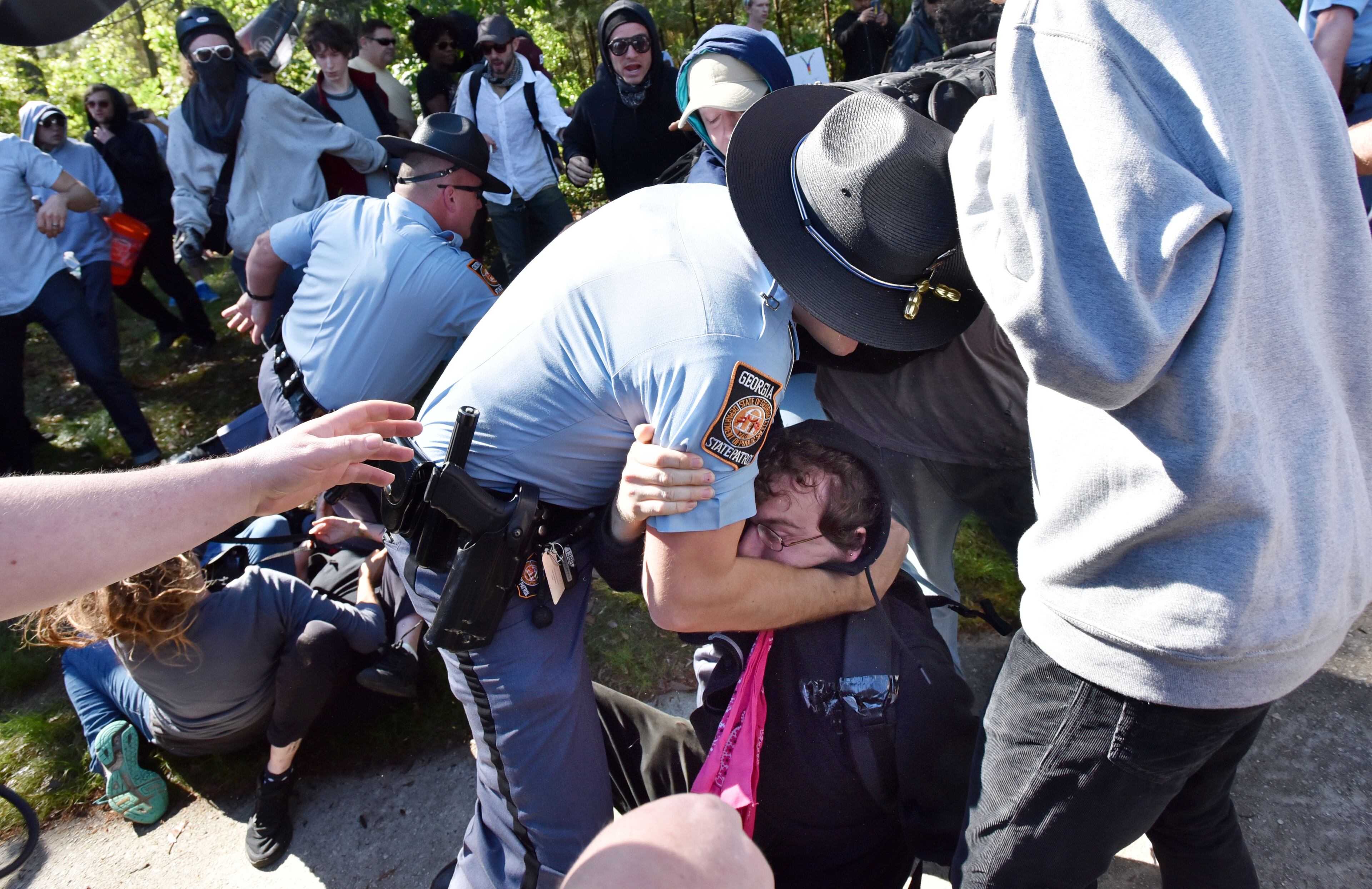 A counter-protester is arrested by police as they try to get past police and to a white power protest at Stone Mountain Park on Saturday, April 23, 2016.