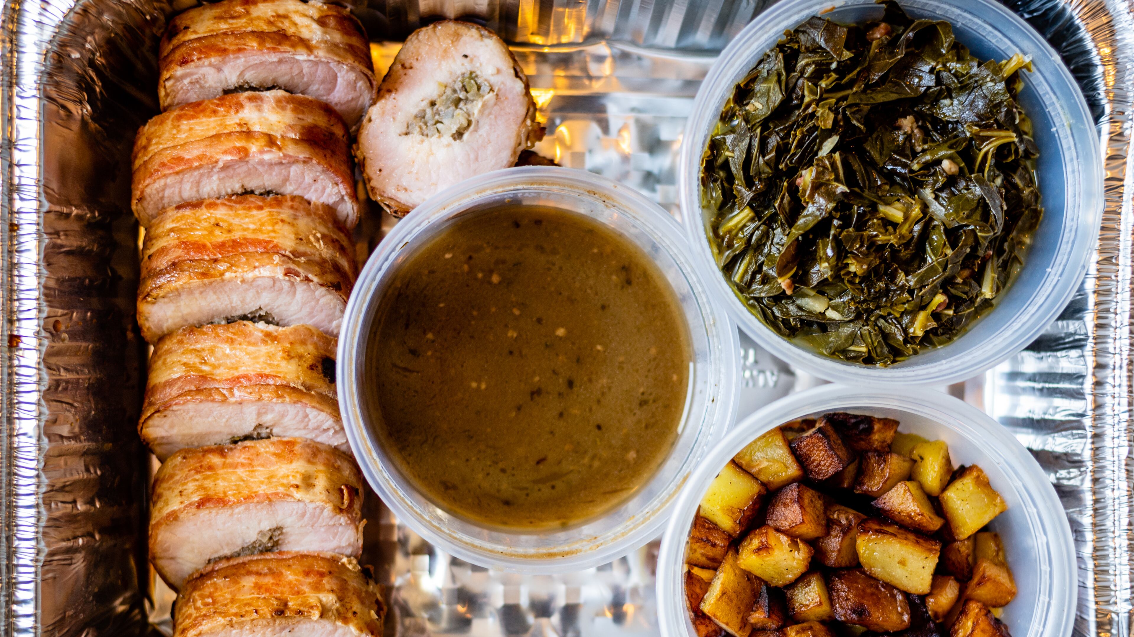 Entree option No. 1 from Lazy Betty included bacon-crusted pork tenderloin stuffed with apple-mushroom dressing, collard greens, roasted potatoes and Madeira pork jus.