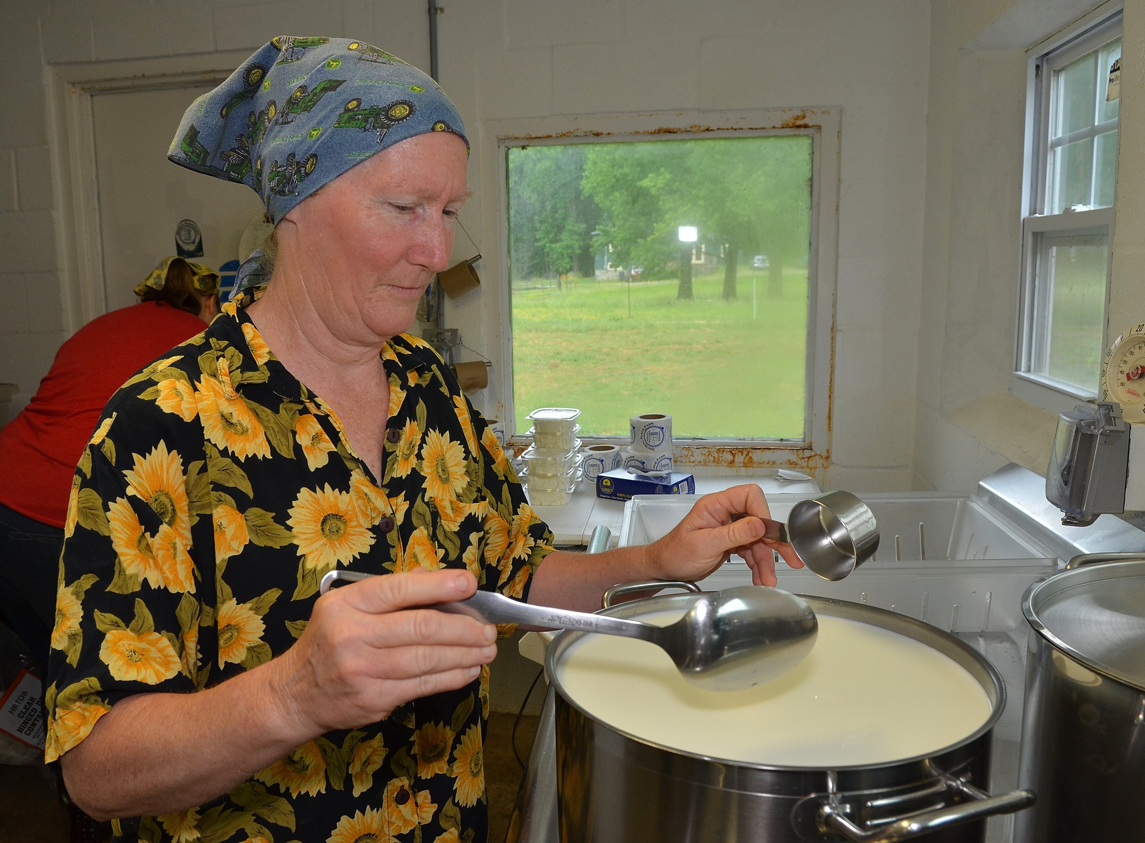 Mary Rigdon, owner of Decimal Place Farm, checks the incubation pots before deciding what kind of cheese to make based on time, temperature and ingredients. This batch was set to be a chevre, a creamy type goat cheese. (Chris Hunt/Special)