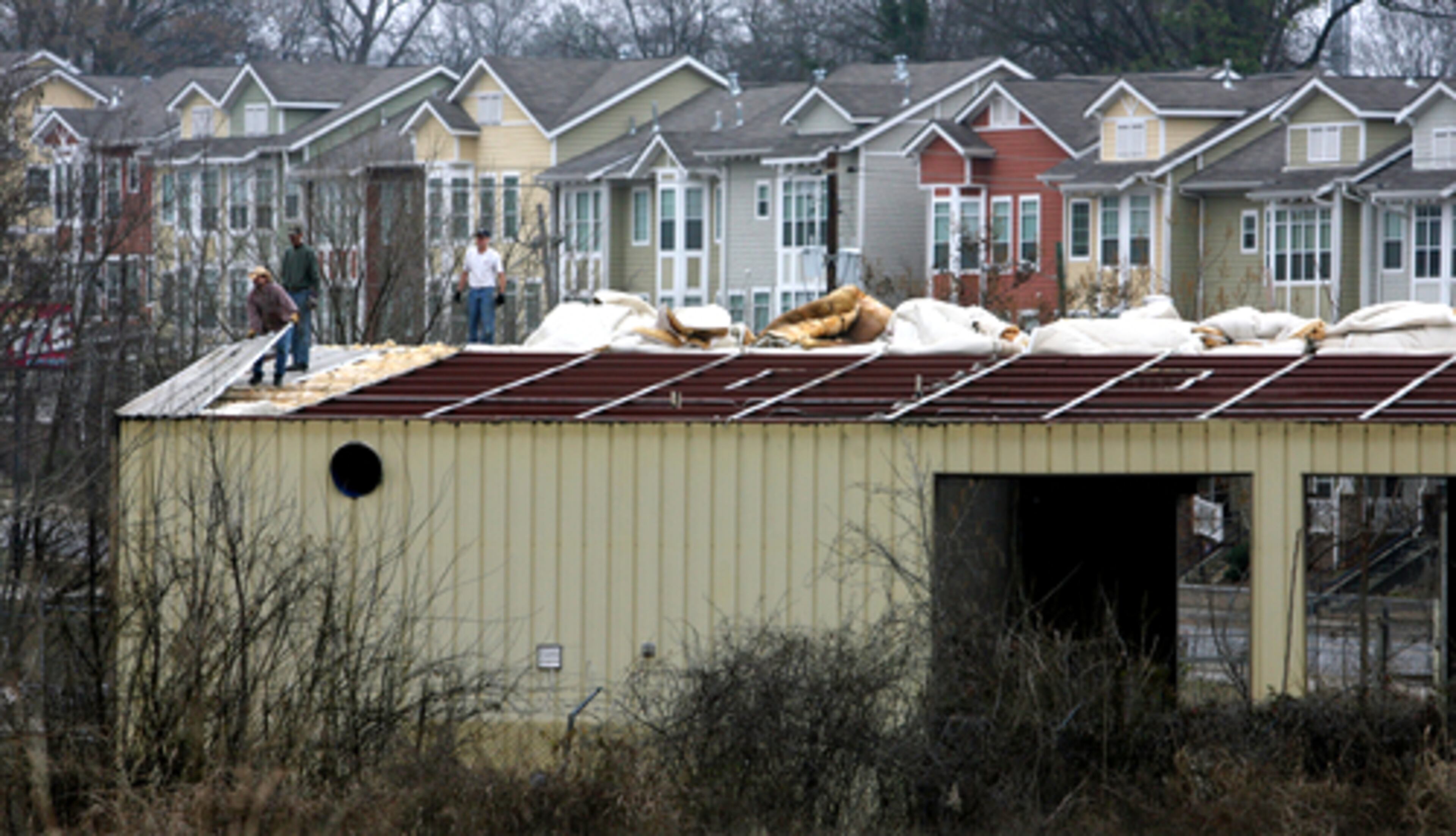 Construction workers take apart the old Peach State Wrecker warehouse on the corner of Boulevard and Englewood Avenue where a 21-acre Beltline park is planned in the area dubbed the Beltline Crossing.