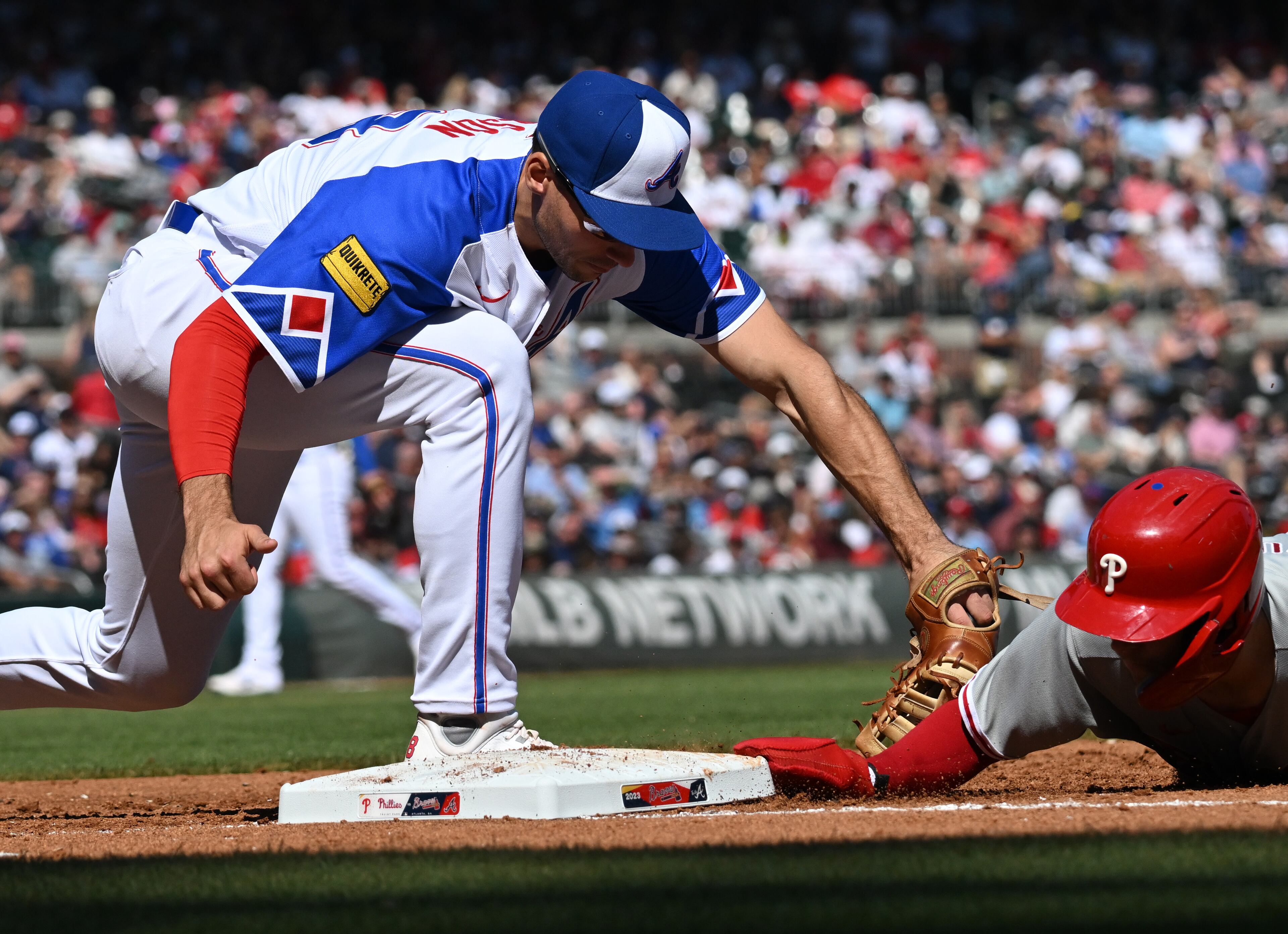 Philadelphia Phillies' shortstop Trea Turner (7) slides back to the first base as Atlanta Braves' first baseman Matt Olson (28) applied a late tag during the third inning at Truist Park, Saturday, May 27, 2023, in Atlanta. (Hyosub Shin / Hyosub.Shin@ajc.com)
