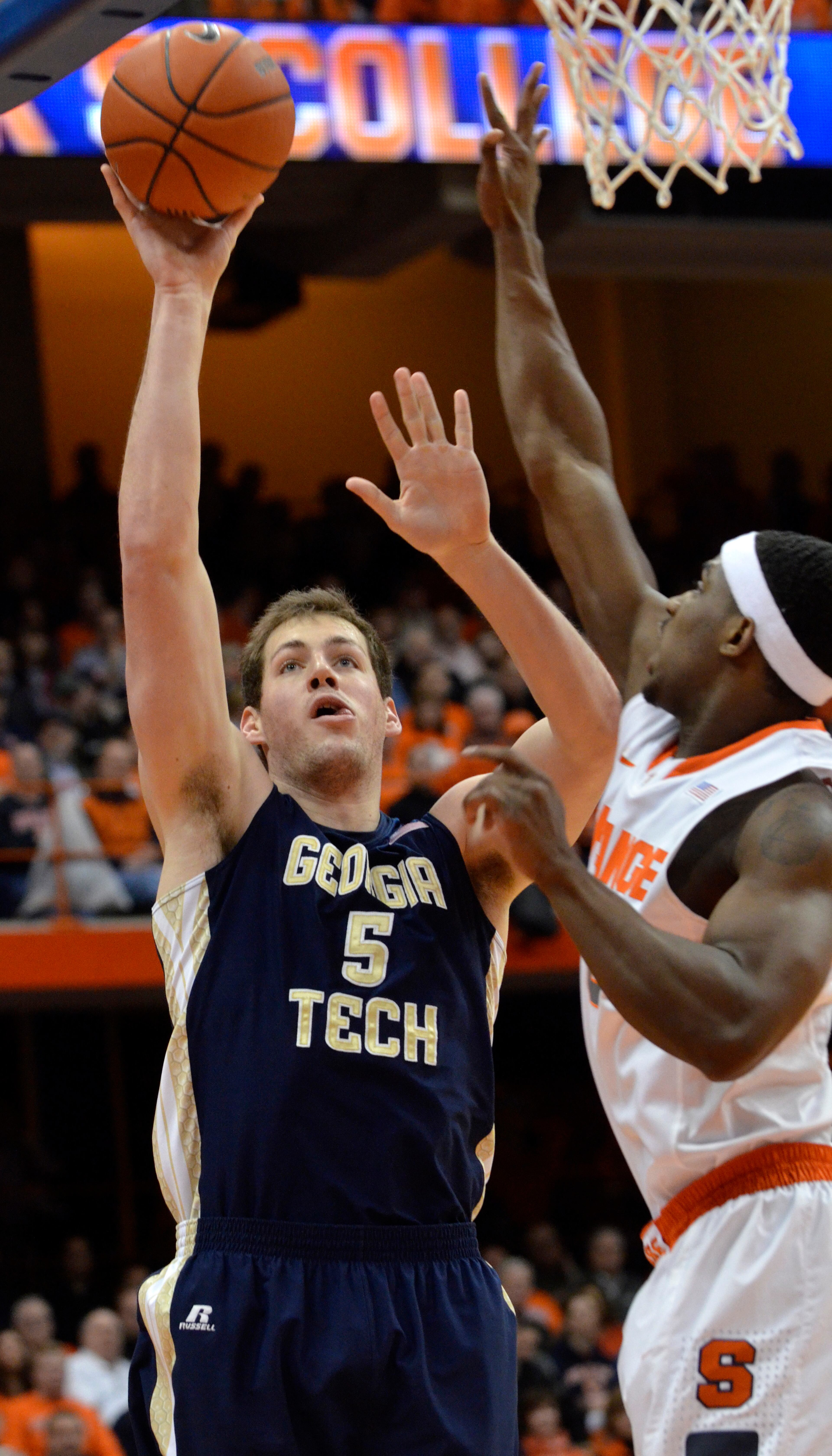 Georgia Tech's Daniel Miller scores against Syracuse's C. J. Fair during the first half of an NCAA college basketball game in Syracuse, N.Y., Tuesday, March 4, 2014.