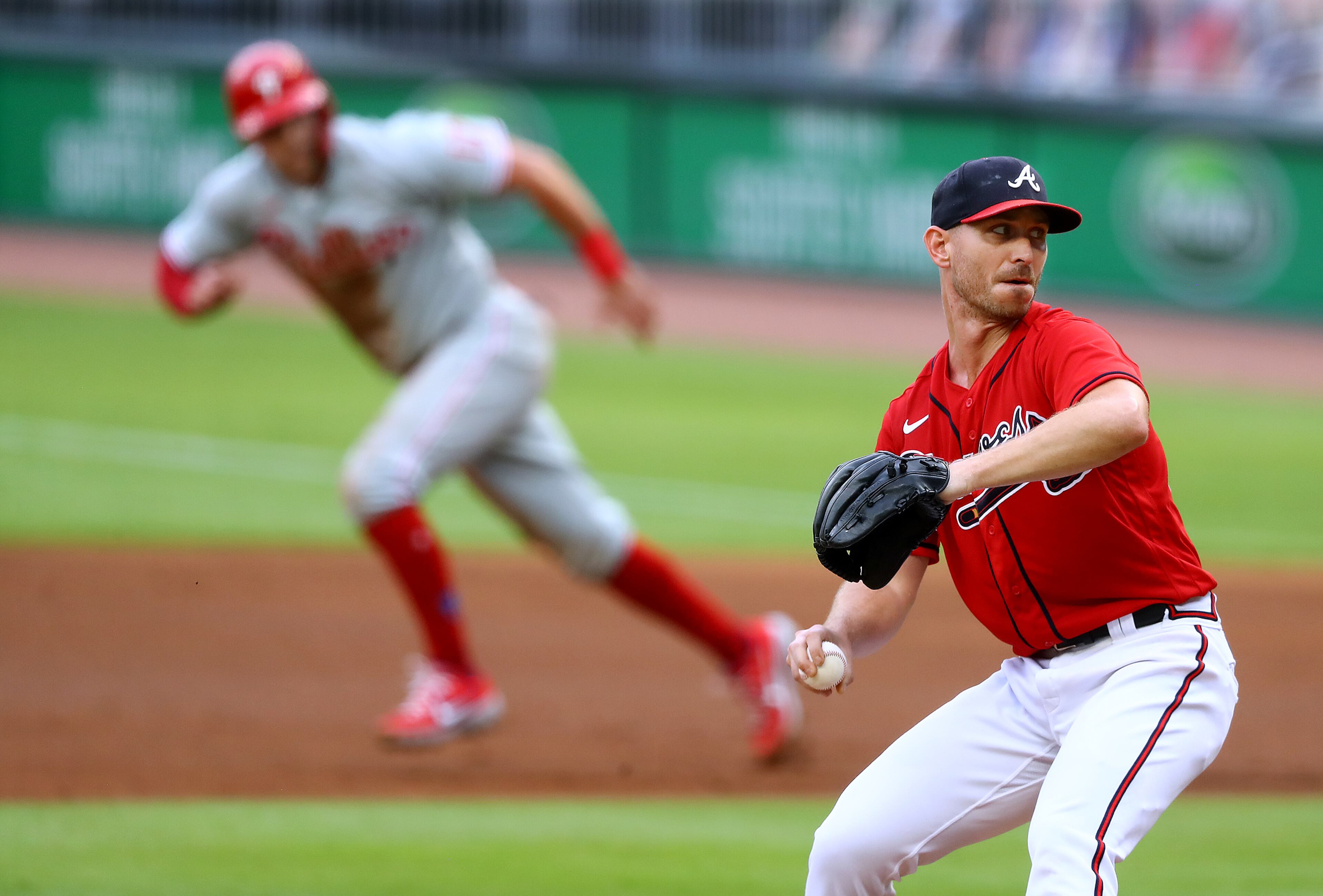 Atlanta Braves starting pitcher Josh Tomlin delivers as Philadelphia Phillies Rhys Hoskins breaks to second base during the first inning in a MLB baseball game on Sunday, August 23, 2020 in Atlanta. Curtis Compton ccompton@ajc.com