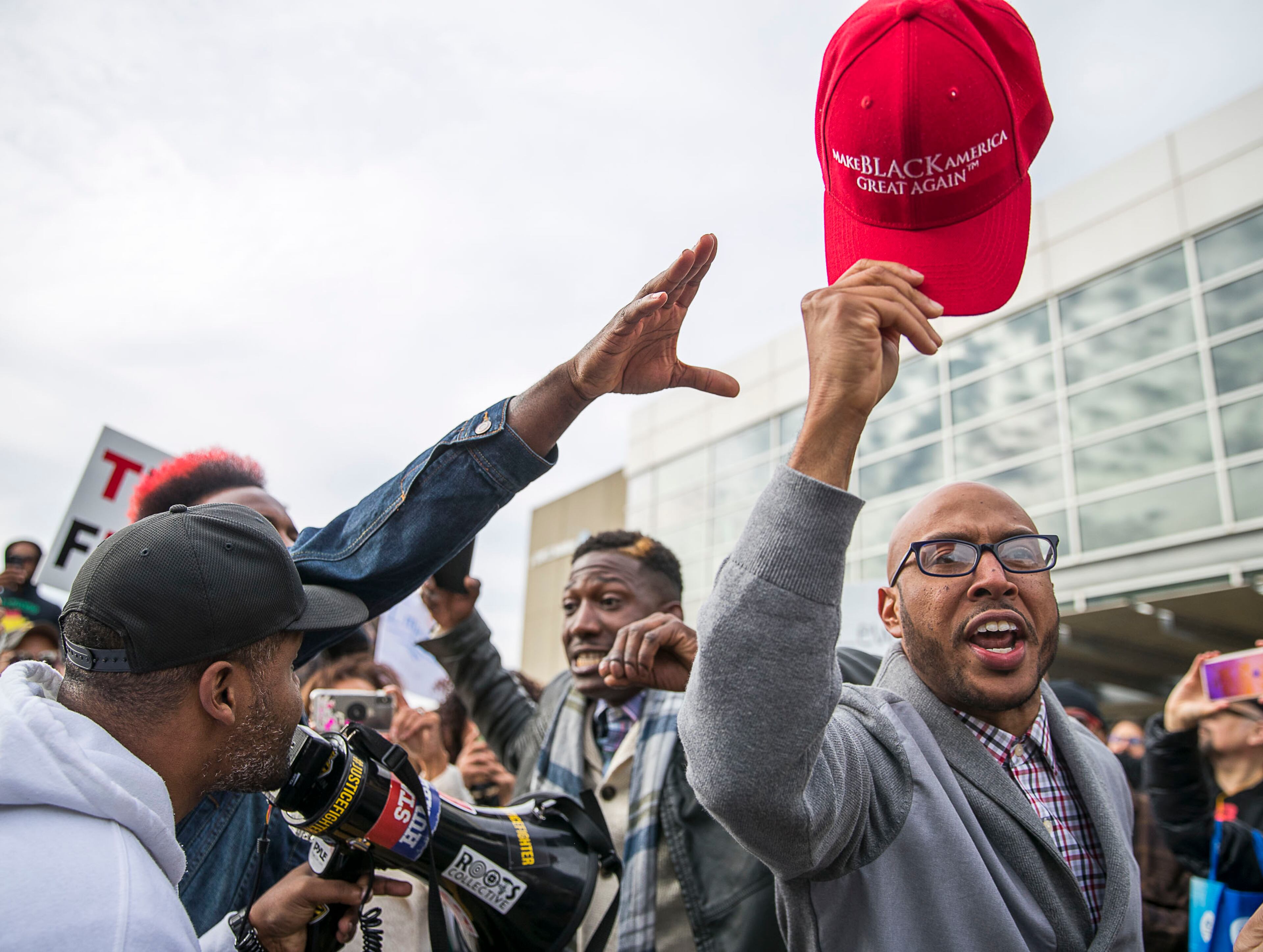 11/08/2019 -- Atlanta, Georgia -- President Donald Trump supporter Tony Smith (right), of College Park, yells "Trump 2020" in a crowd of anti-Trump protestors as they rally outside of the Georgia World Congress Center in downtown Atlanta, Friday, November 8, 2019. President Trump was in Atlanta on Friday to speak to a crowd of African American voters that support his presidency. (Alyssa Pointer/Atlanta Journal Constitution)