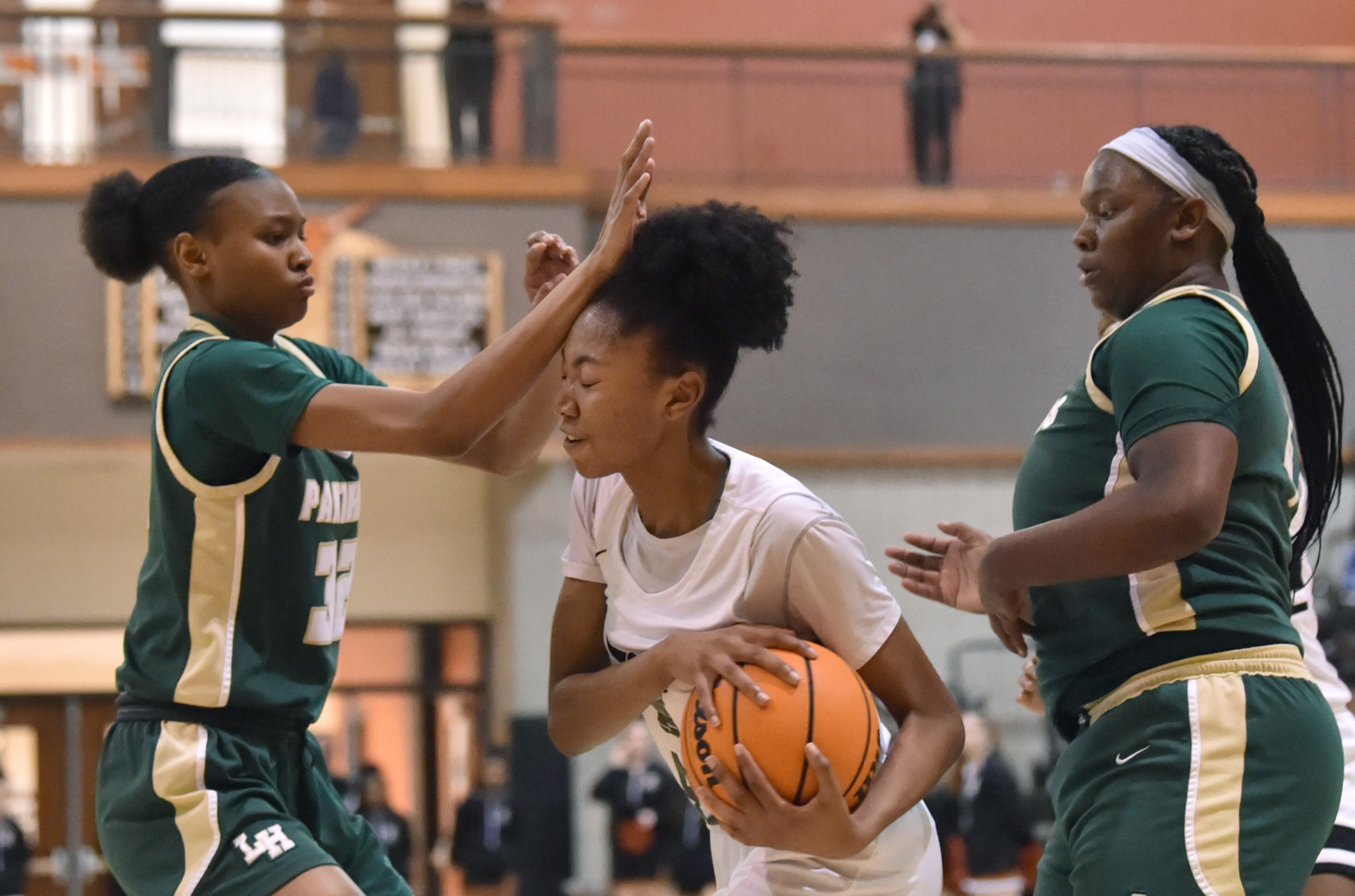 February 25, 2022 Marietta - Langston Hughes' Mallory Holmes (32) and Kell’s Amaya Moss (42) collide in the second half of 2022 Georgia Girls State Basketball playoffs at Kell high school in Marietta on Friday, February 25, 2022. Kell won 57-50 over Langston Hughes. (Hyosub Shin / Hyosub.Shin@ajc.com)