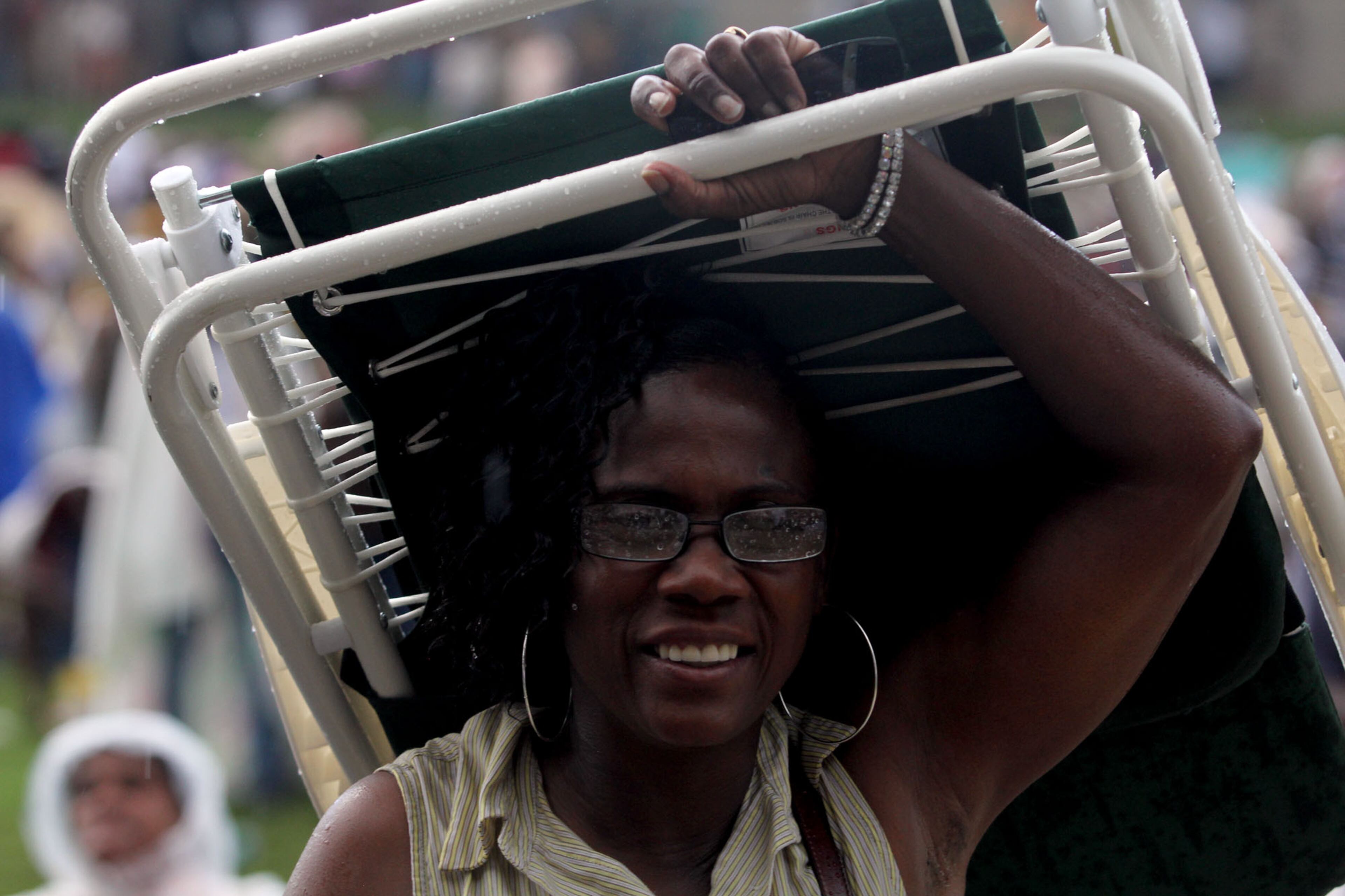 A brief rain storm has people running for cover during the 2013 Flashback Festival at Aaron's Amphitheatre at Lakewood in Atlanta on Saturday.