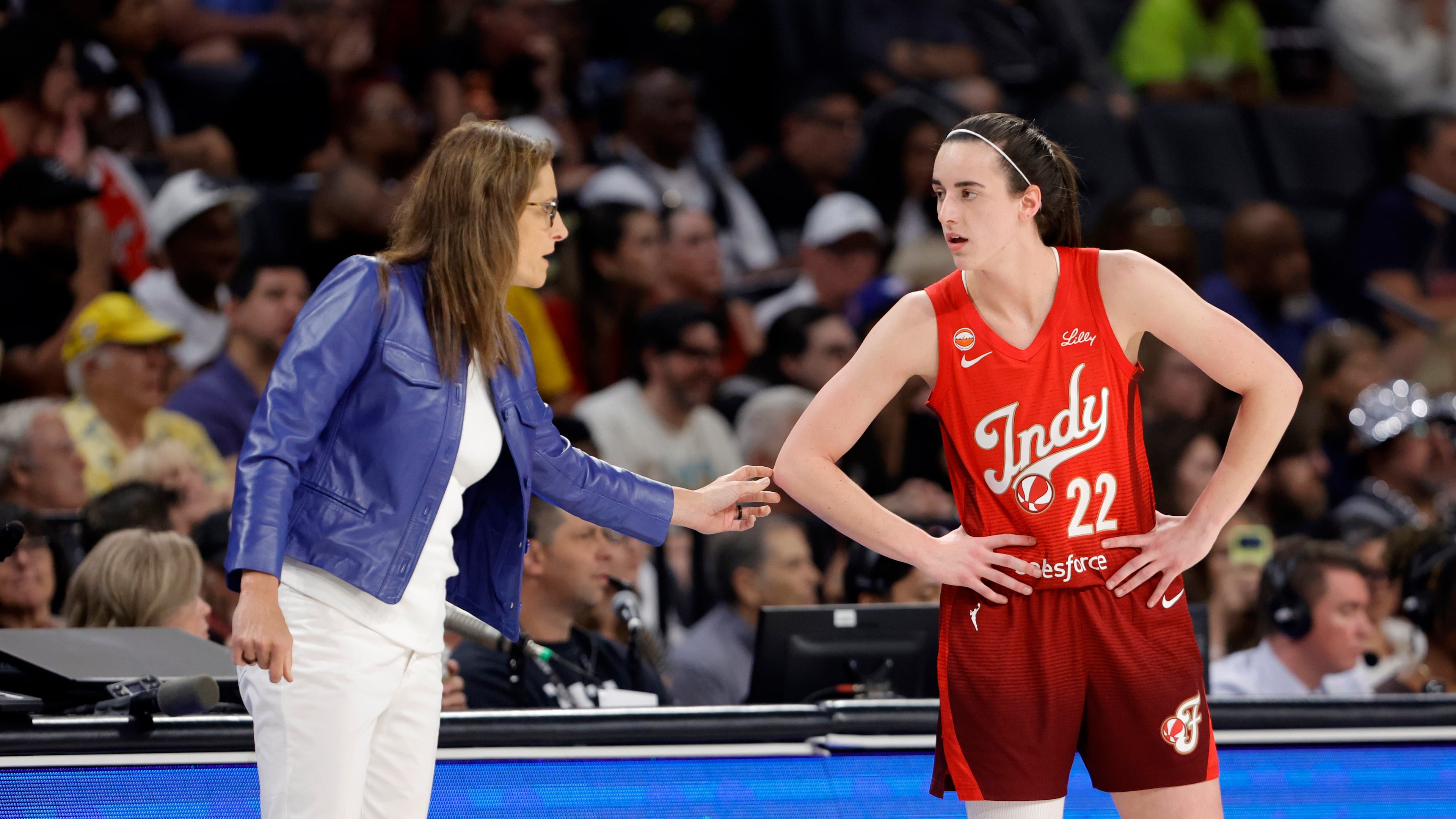 Indiana Fever head coach Stephanie White talks with Indiana Fever guard Caitlin Clark (22) during the first half of an WNBA basketball game against the Las Vegas Aces Sunday, July 12, 2026, in Las Vegas. (Steve Marcus/Las Vegas Sun via AP)
