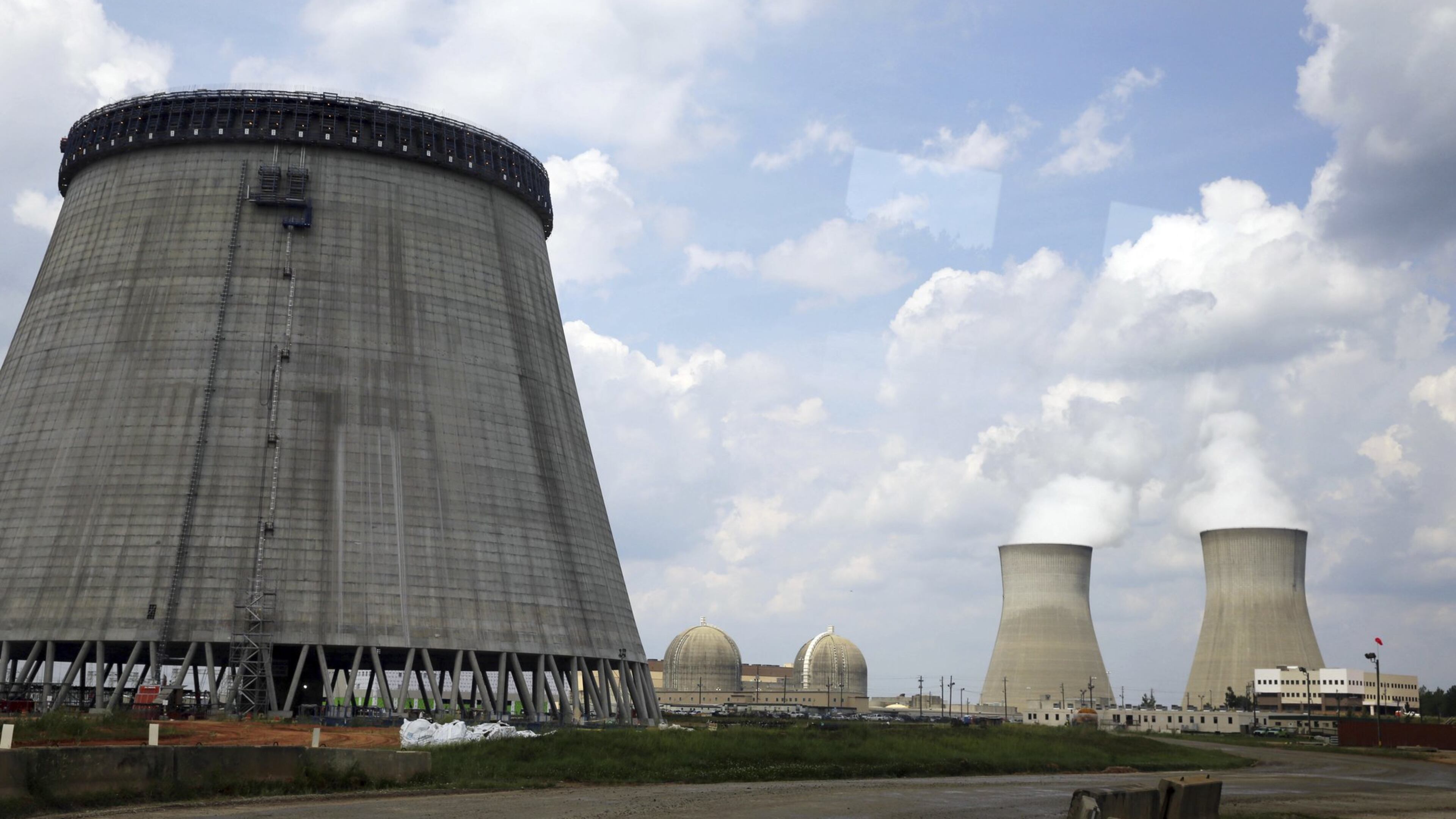 A cooling tower for one of two new nuclear reactors at Plant Vogtle rises in this 2014 construction photo. A key contractor’s bankruptcy has put the project’s future in question. (AP Photo/John Bazemore, File)
