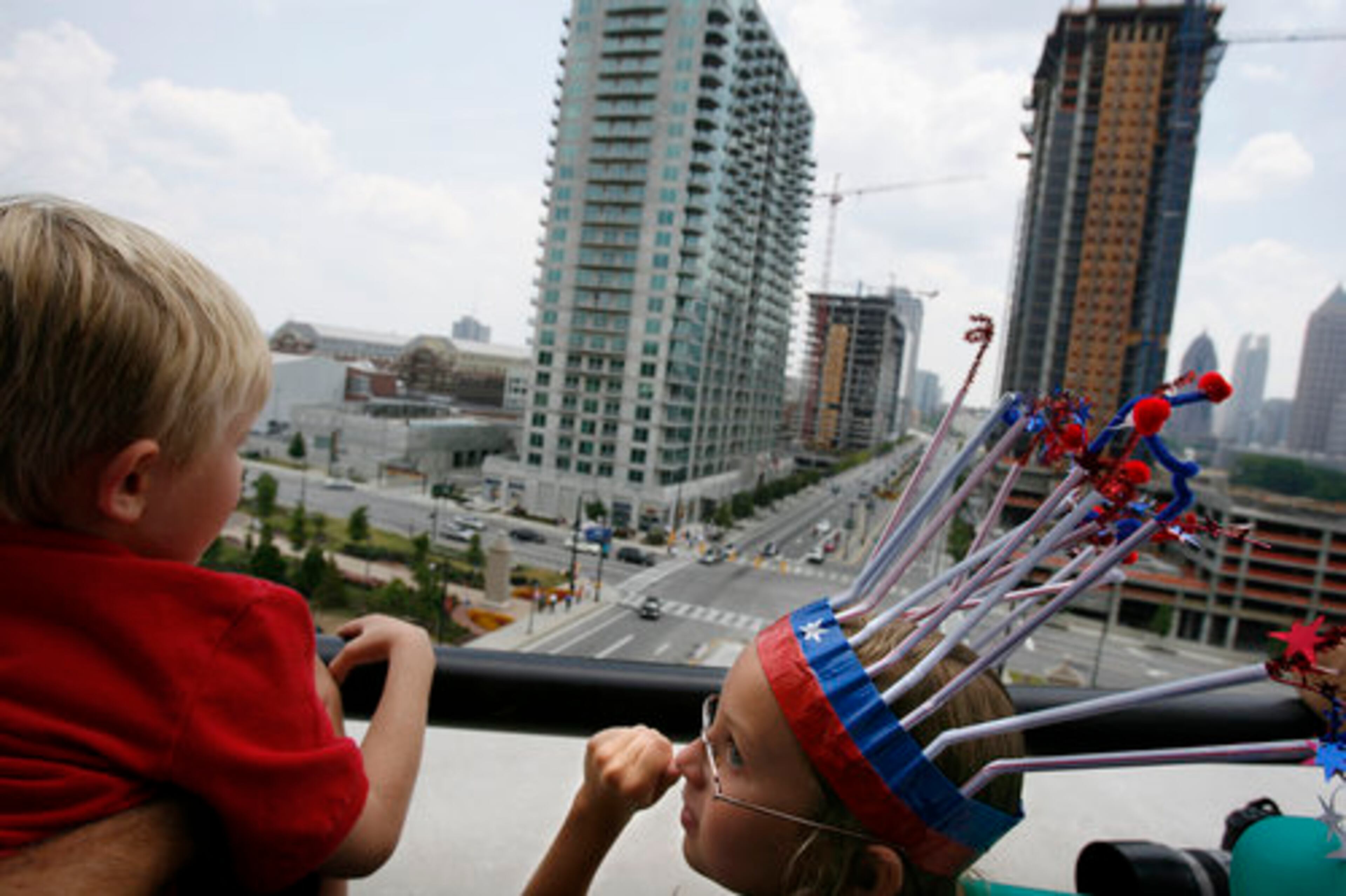 Abigail Borden, 9, right, of Atlanta, looks out on 17th Street from the viewing deck of The Millennium Gate with her brother, Jackson, 6.