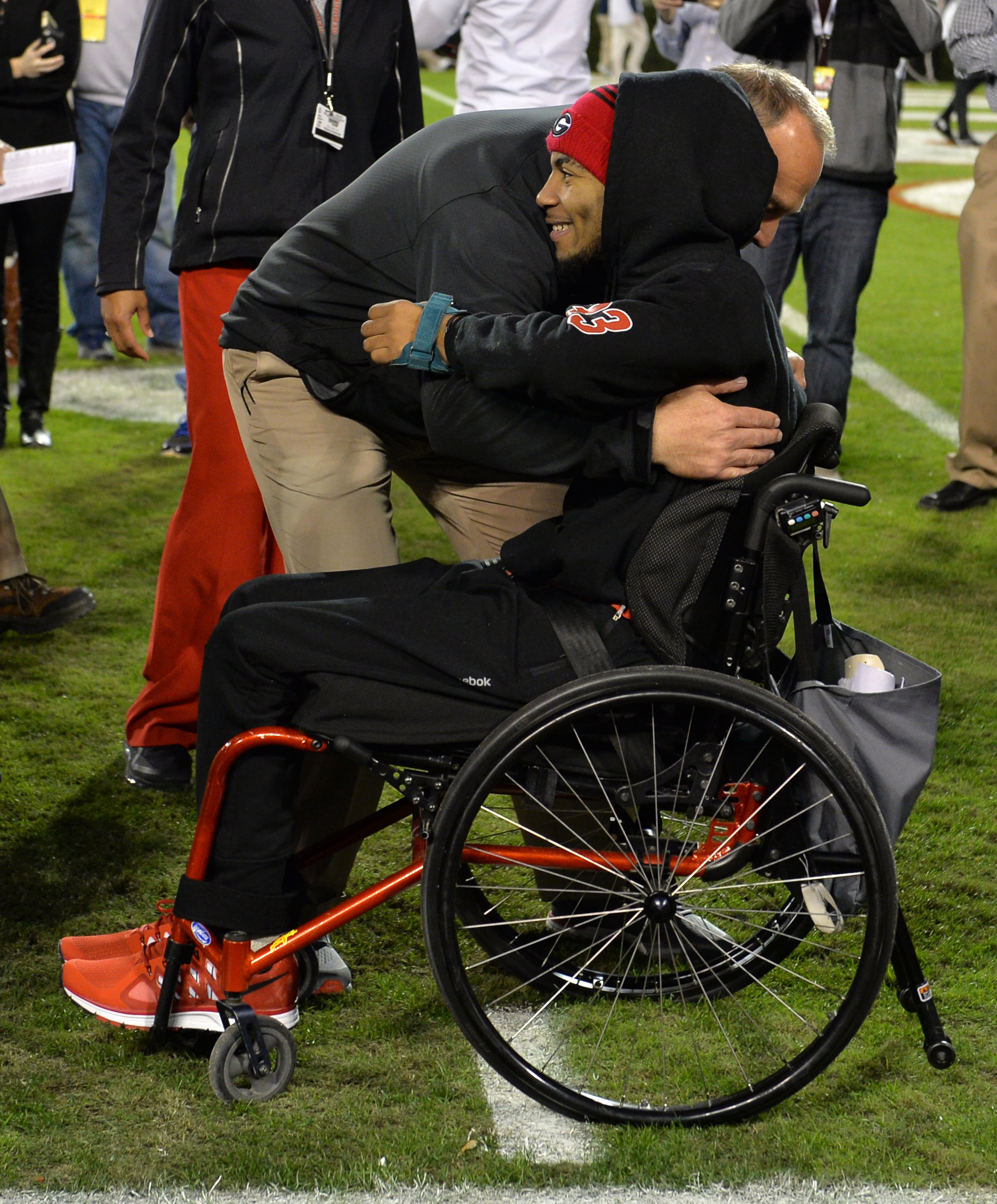 Devon Gales, the Southern University player paralyzed in a early season game against Georgia, received a hug from Georgia head coach Mark Richt before a 2015 game. Gales was greeted by players as they entered the stadium in Athens. BRANT SANDERLIN/BSANDERLIN@AJC.COM