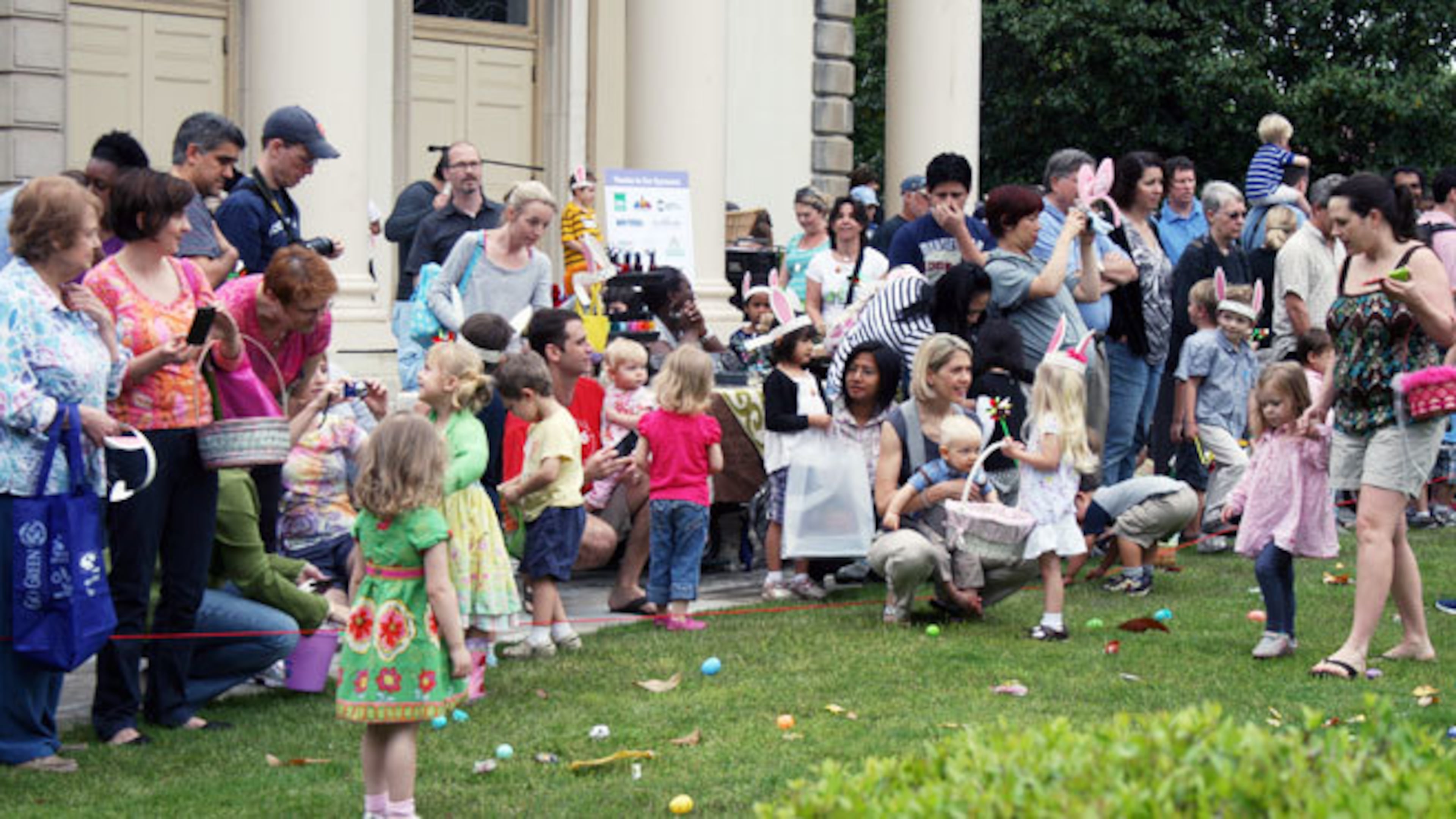 Children fill their baskets at the Decatur Business Association Easter Egg Hunt.