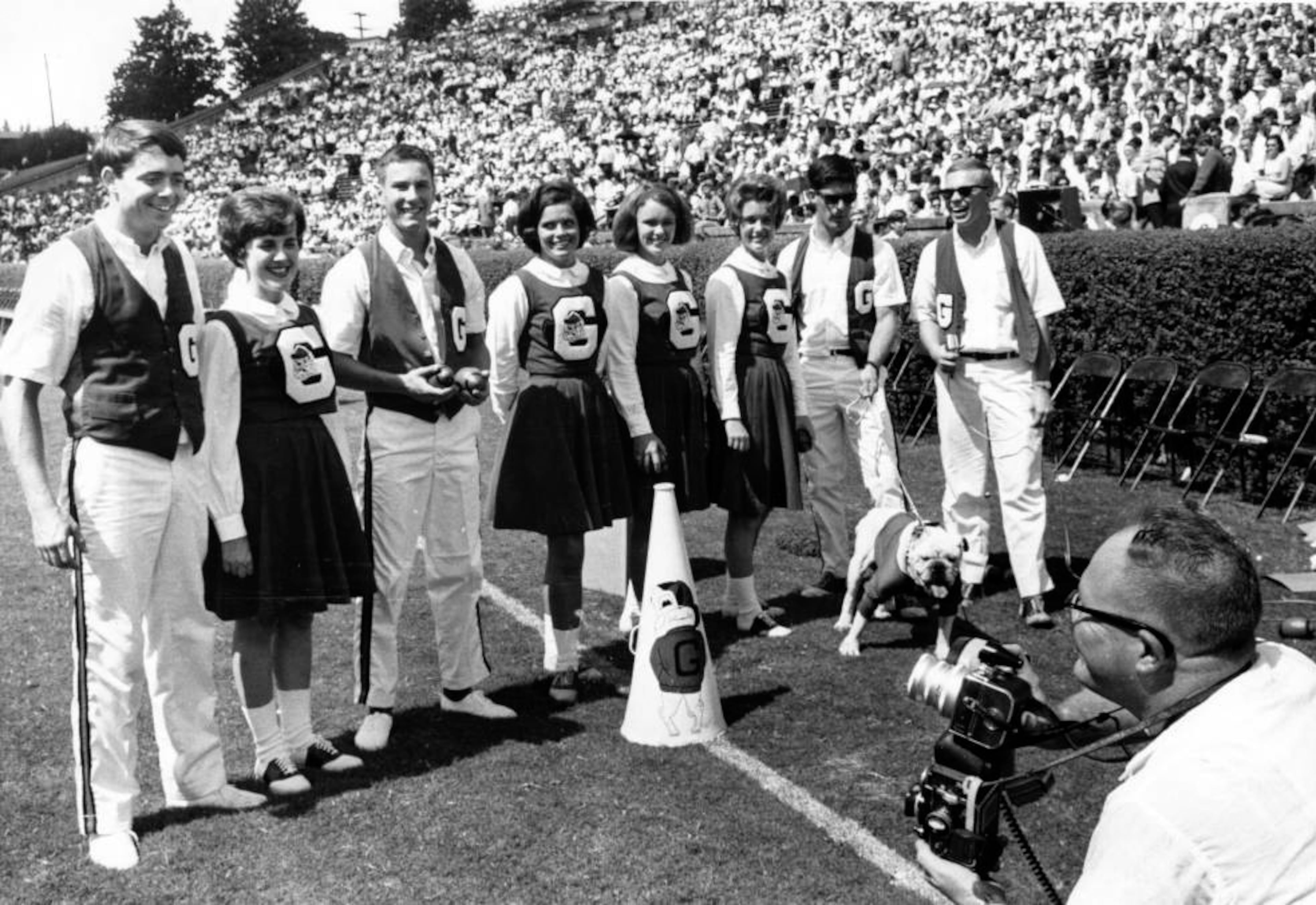 An undated photo of Atlanta Journal-Constitution photographer Charles Pugh taking photos of the cheerleaders at a Georgia versus Alabama football game in Athens.