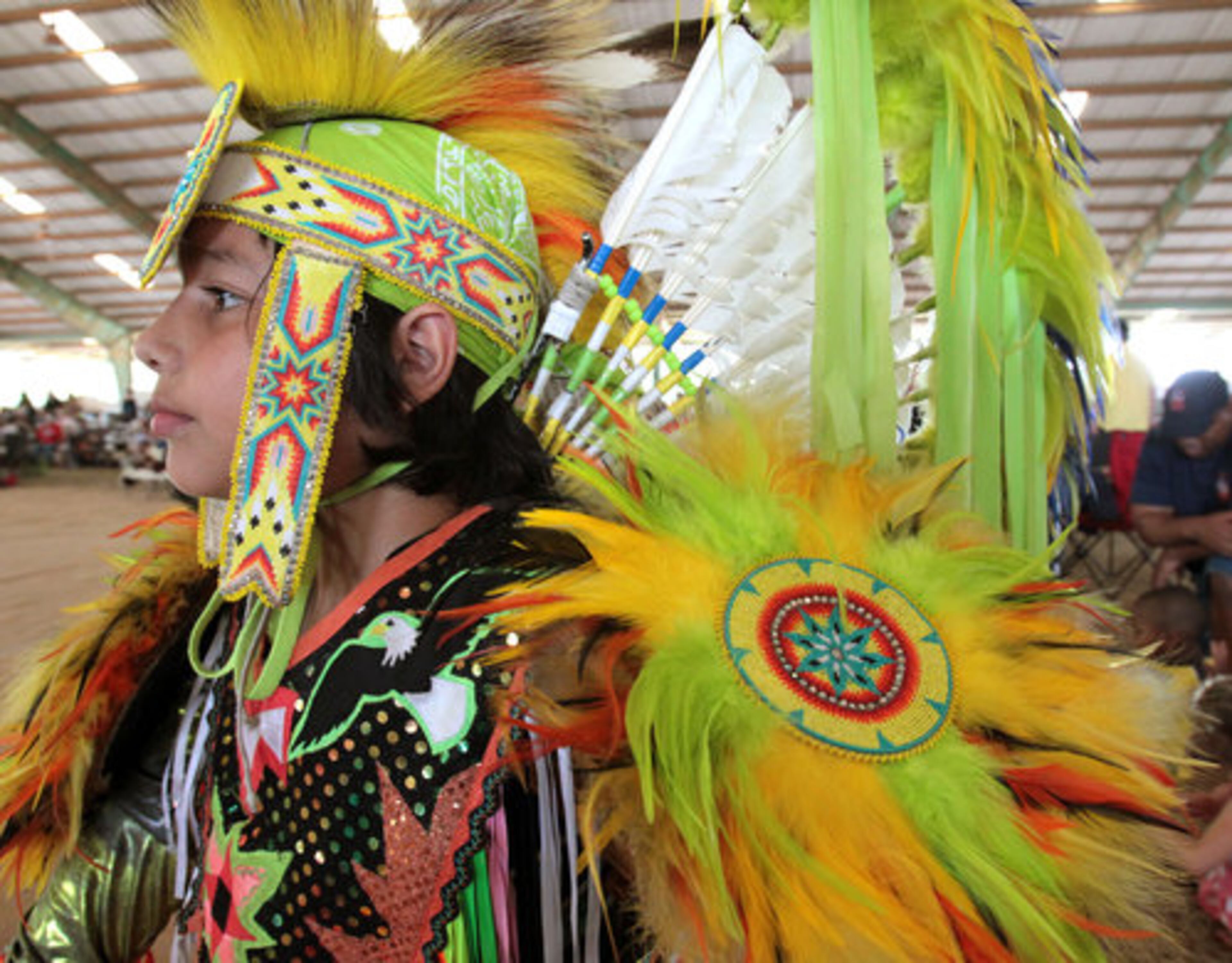Jonathan Jumper, 12, of Kennesaw, prepares to compete in the men's fancy division of the American Indian Festival. Jumper's family is originally from Cherokee, NC., and is an Eastern Band of Cherokee Indian of the Snowbird Community. Jonathan's father, Robin, is a drummer and performer in the festival.