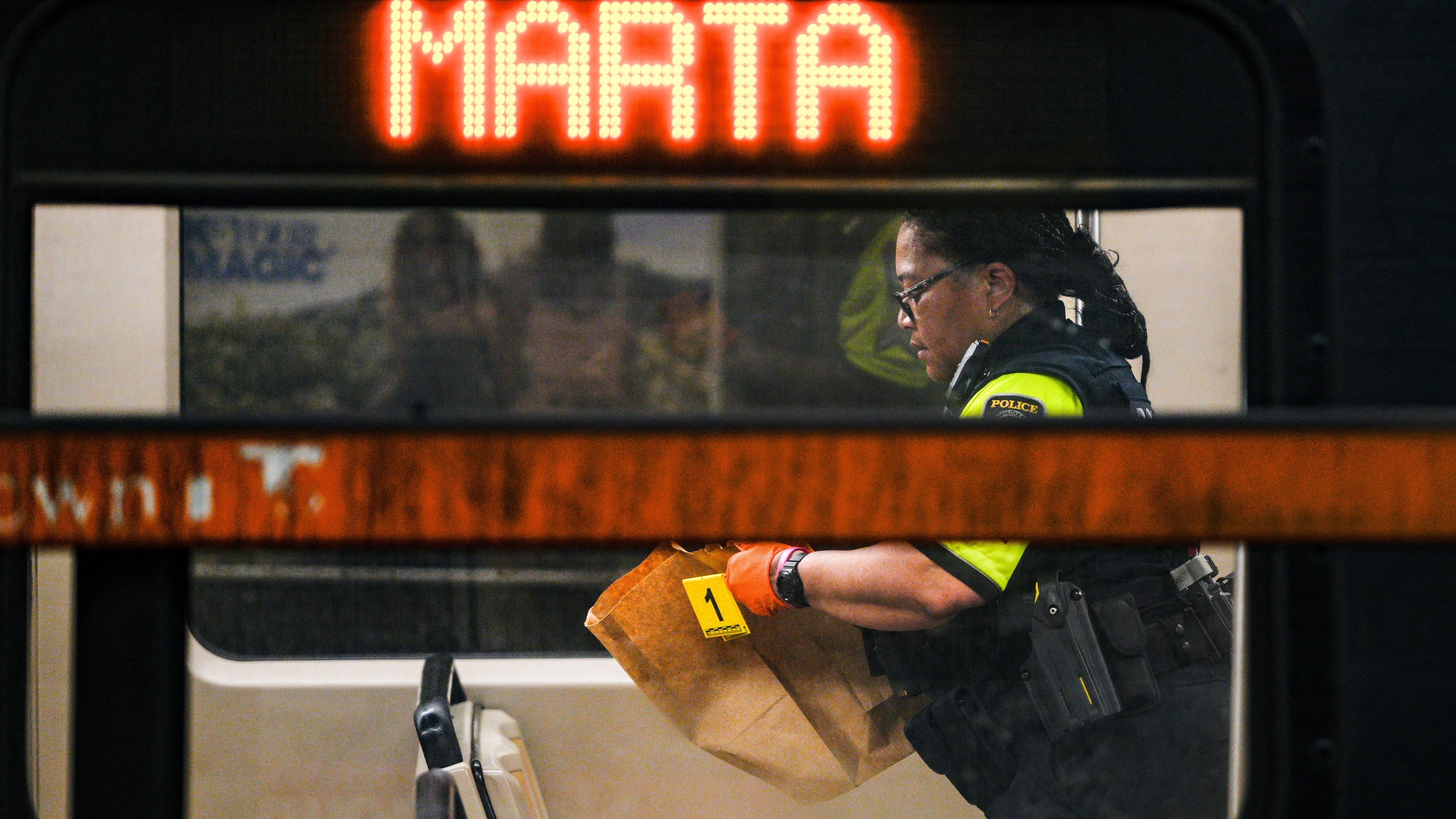 A MARTA police officer collects evidence from a train at the Midtown station on Friday, June 5, 2026. (Ben Hendren for the AJC)